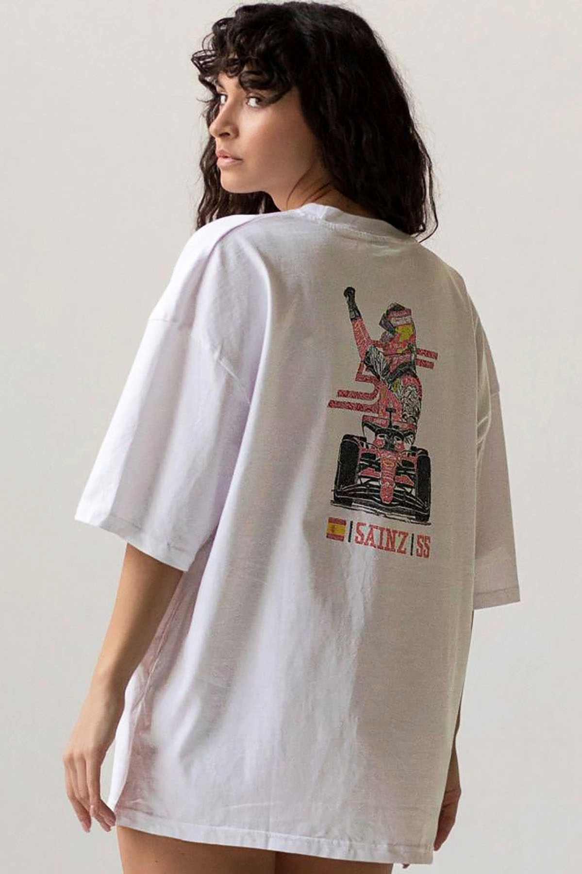 Model wearing Utmost Province Carlos Sainz inspired Ferrari F1 shirt, showcasing the graphic design on the back of the Ferrari F1 merch.