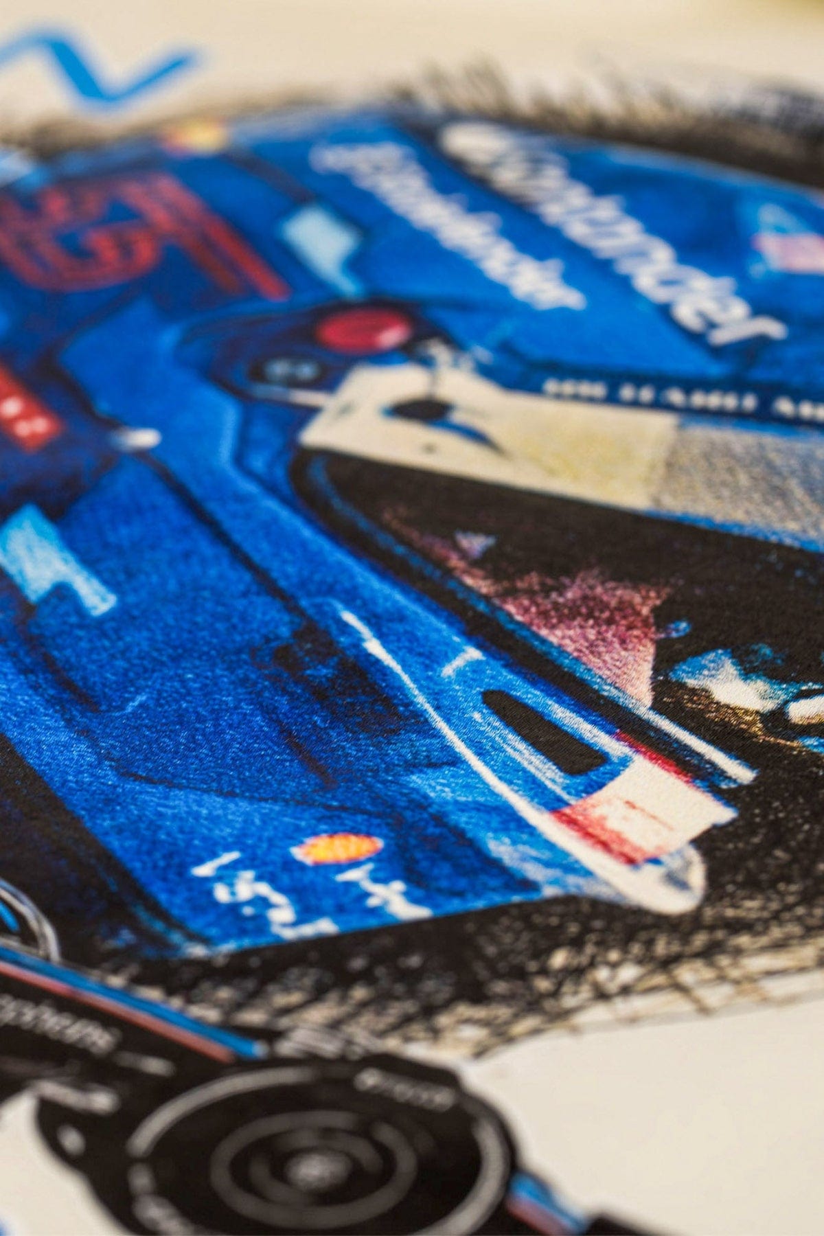 Close-up of Utmost Province graphic design on a beige shirt.