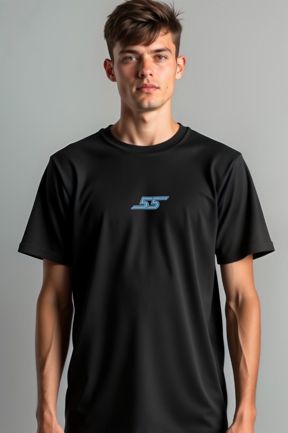 Person wearing a black t-shirt with a logo with a gray background.