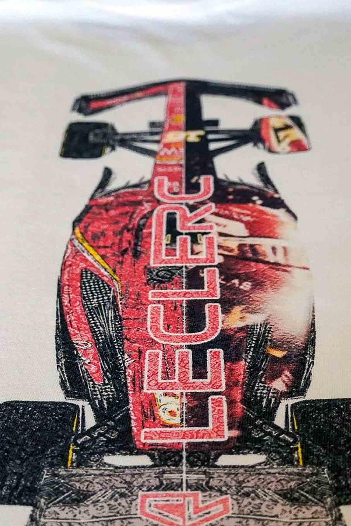 Utmost Province Ferrari F1-inspired race car t-shirt laid flat on a table, highlighting the graphic design on the back of the Formula 1 shirt.