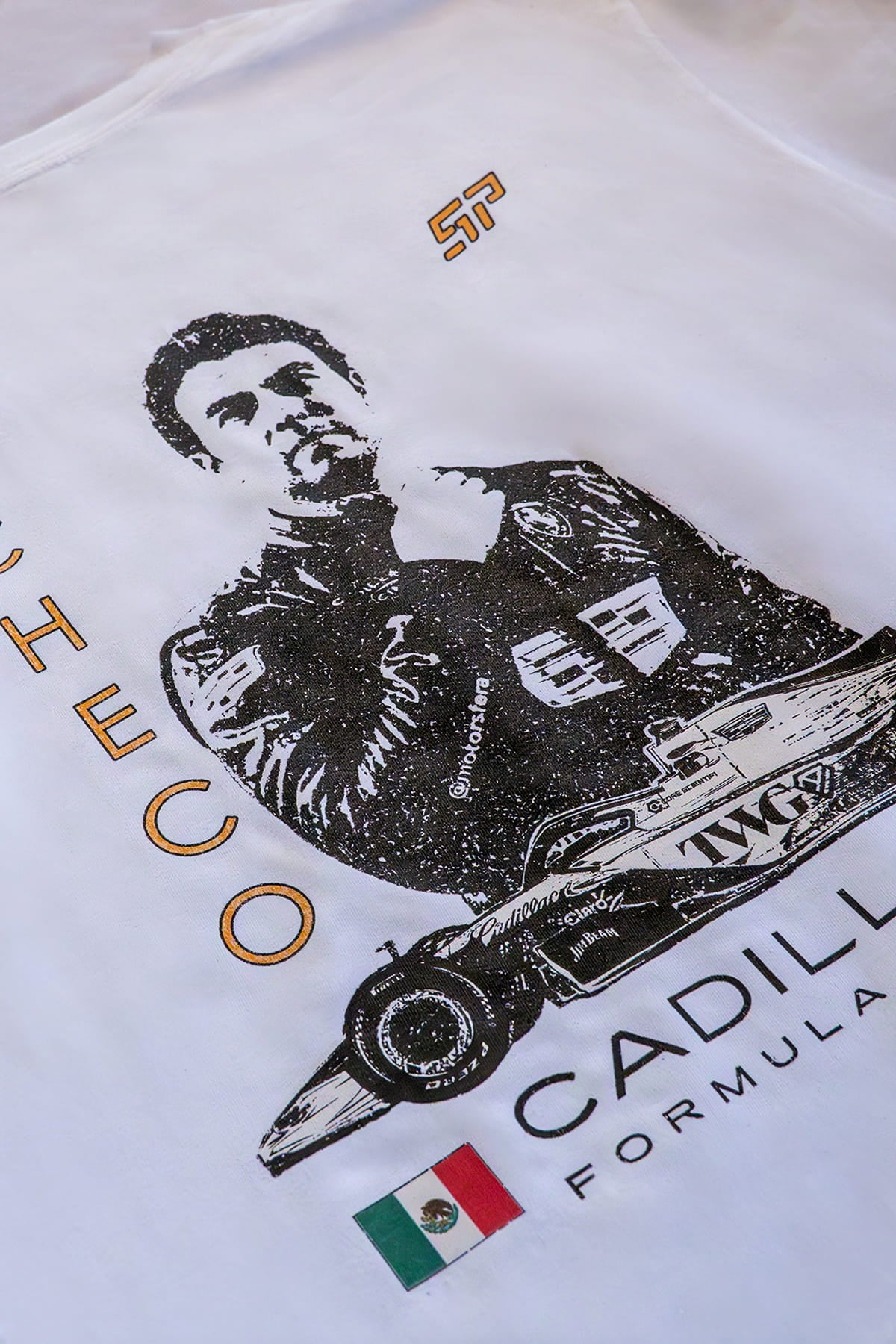 Close-up of custom white Cadillac F1 shirt by Utmost Province, highlighting Checo-inspired silhouette graphic design and print detail.
