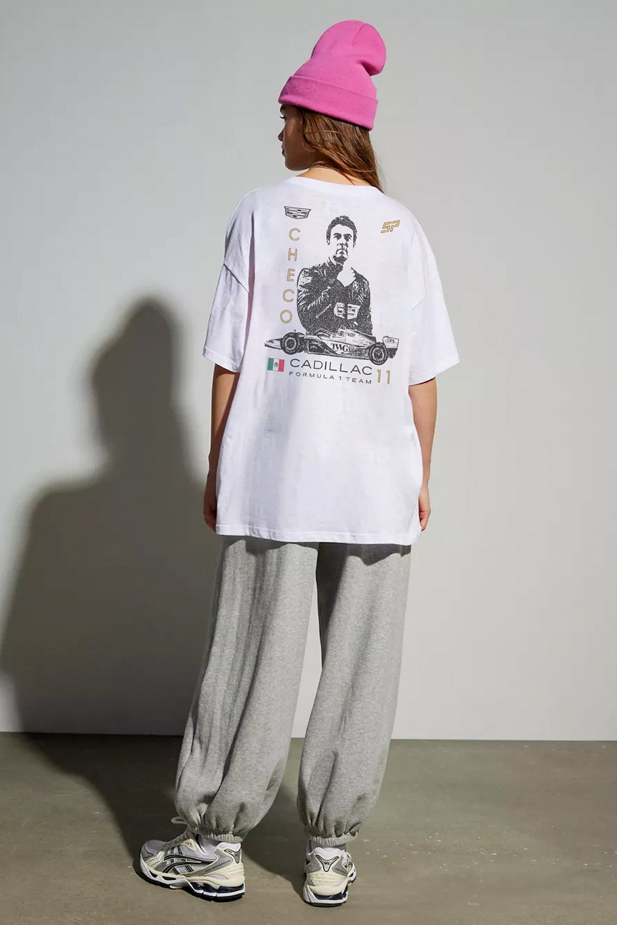 Model wearing white Cadillac F1 shirt by Utmost Province, back view highlighting Sergio Perez-inspired silhouette graphic design.