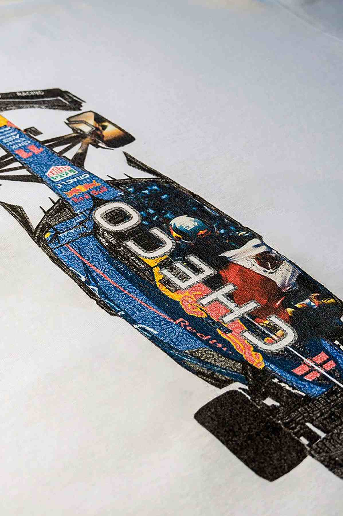 Utmost Province Checo Perez F1 shirt laid flat on a table, highlighting the graphic design on the back of the Red Bull racing merchandise.