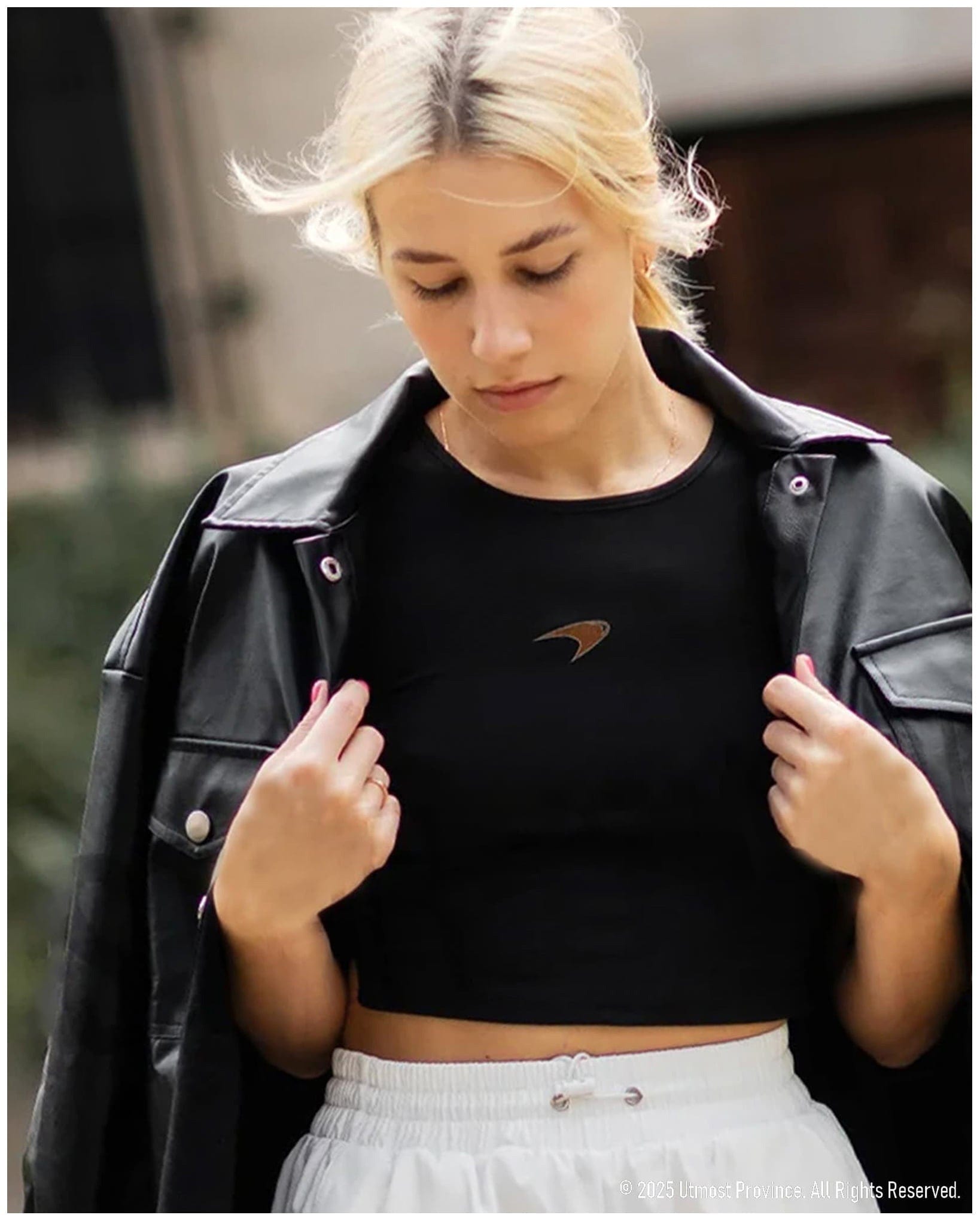 Woman wearing a crop tank top, showcasing Utmost Province's womens F1 merch collection.