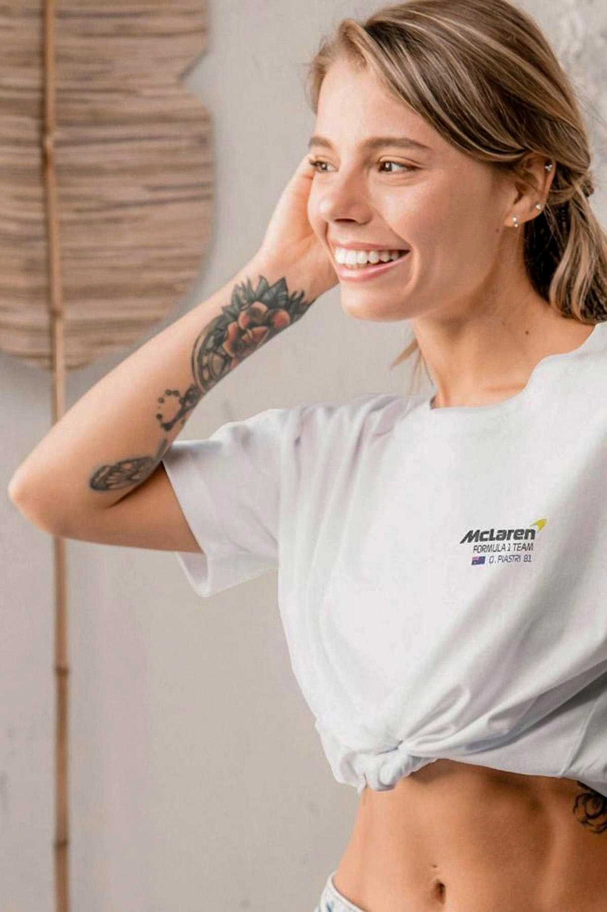 Model wearing a custom Mclaren F1 shirt inspired by Oscar Piastri, showcasing the front left chest graphic design.