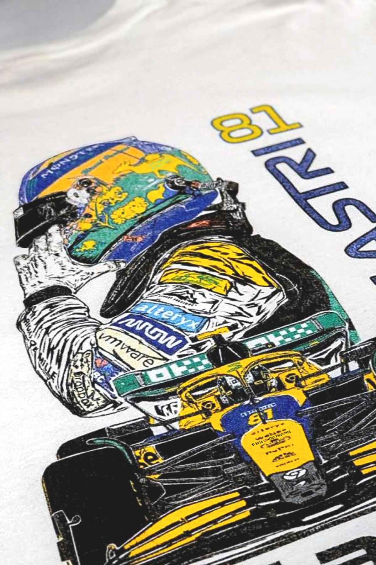 Utmost Province Mclaren F1 shirt laid flat on a table, highlighting the exclusive custom Oscar Piastri merch graphic design on the back of the unisex t shirt.
