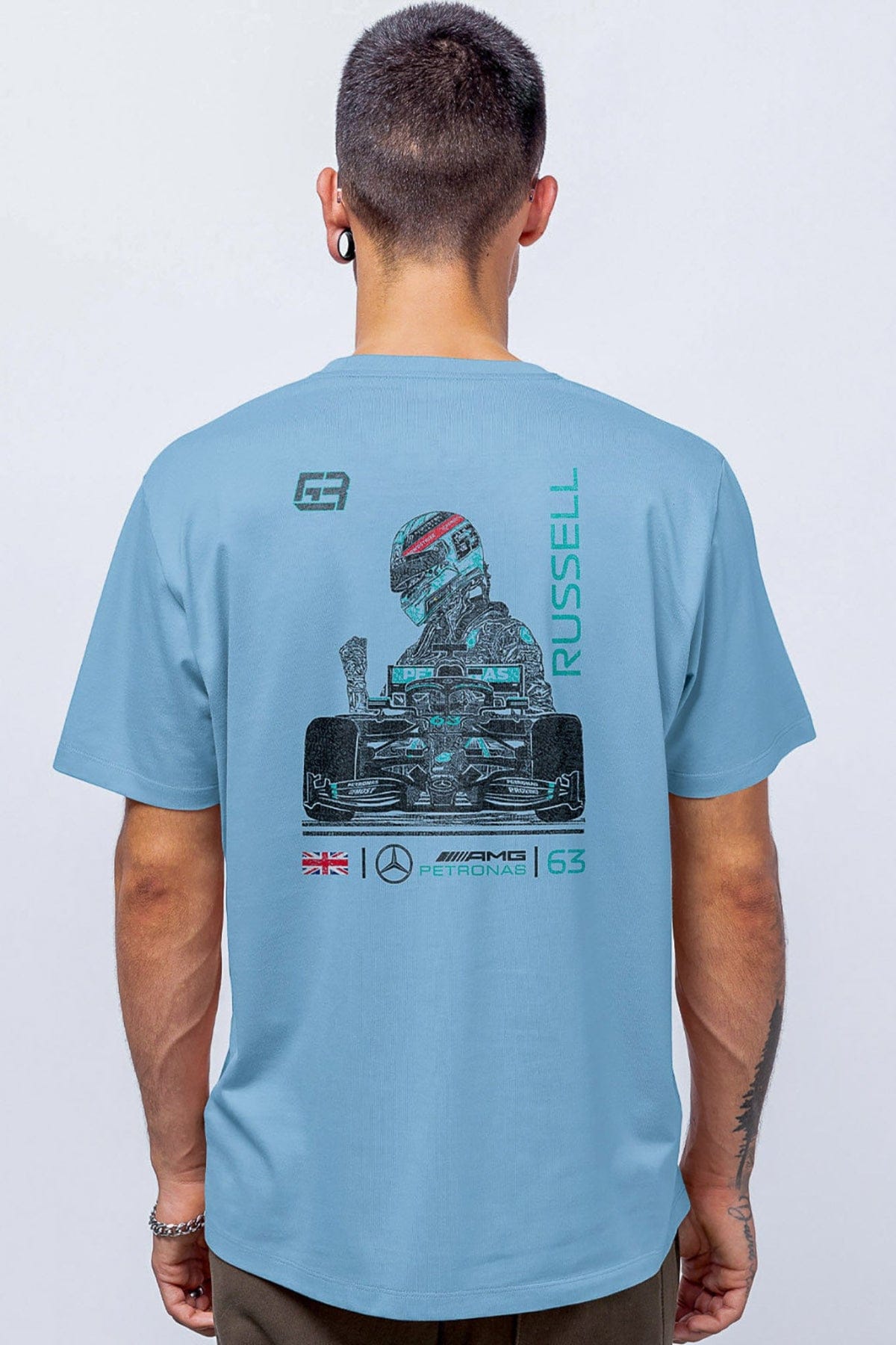 Model wearing a light blue Mercedes F1 shirt, showcasing the graphic design on the back.