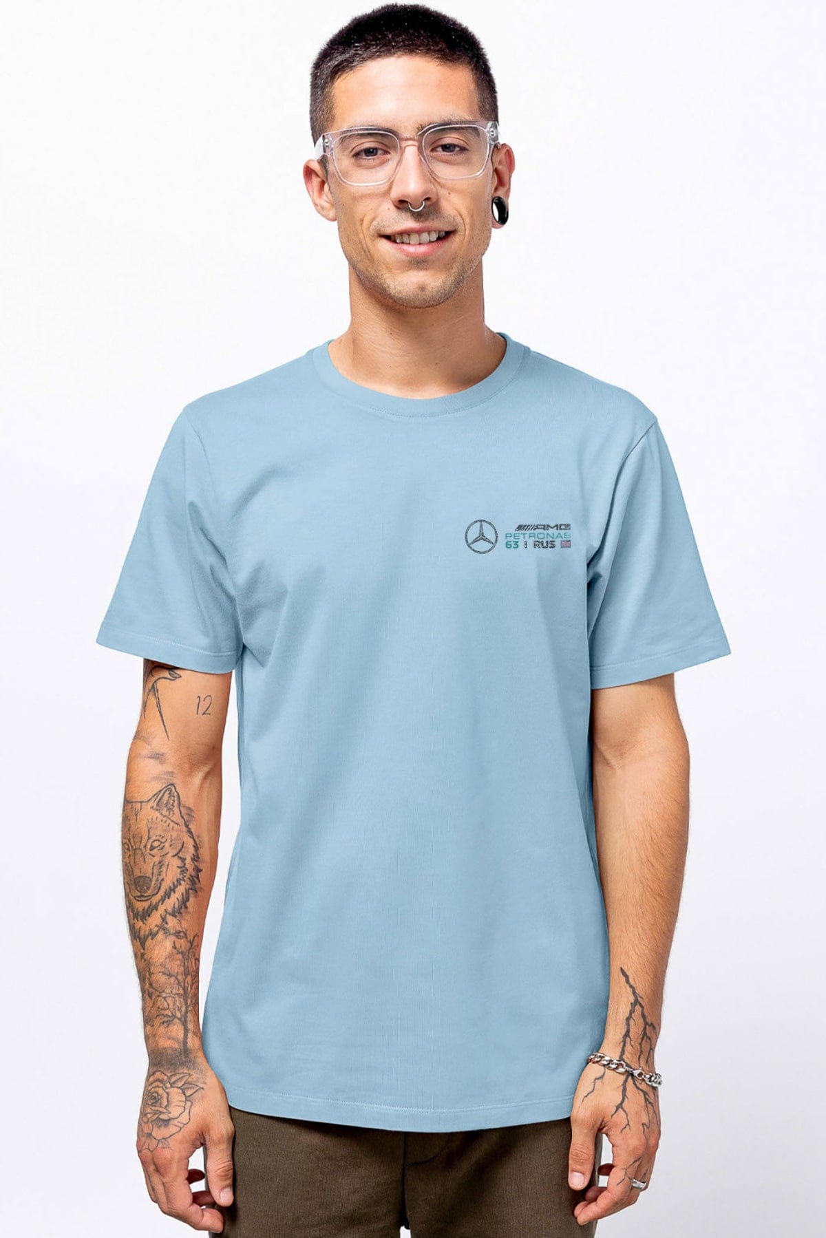 Model wearing a light blue Mercedes F1 shirt, showcasing the graphic design on the front.