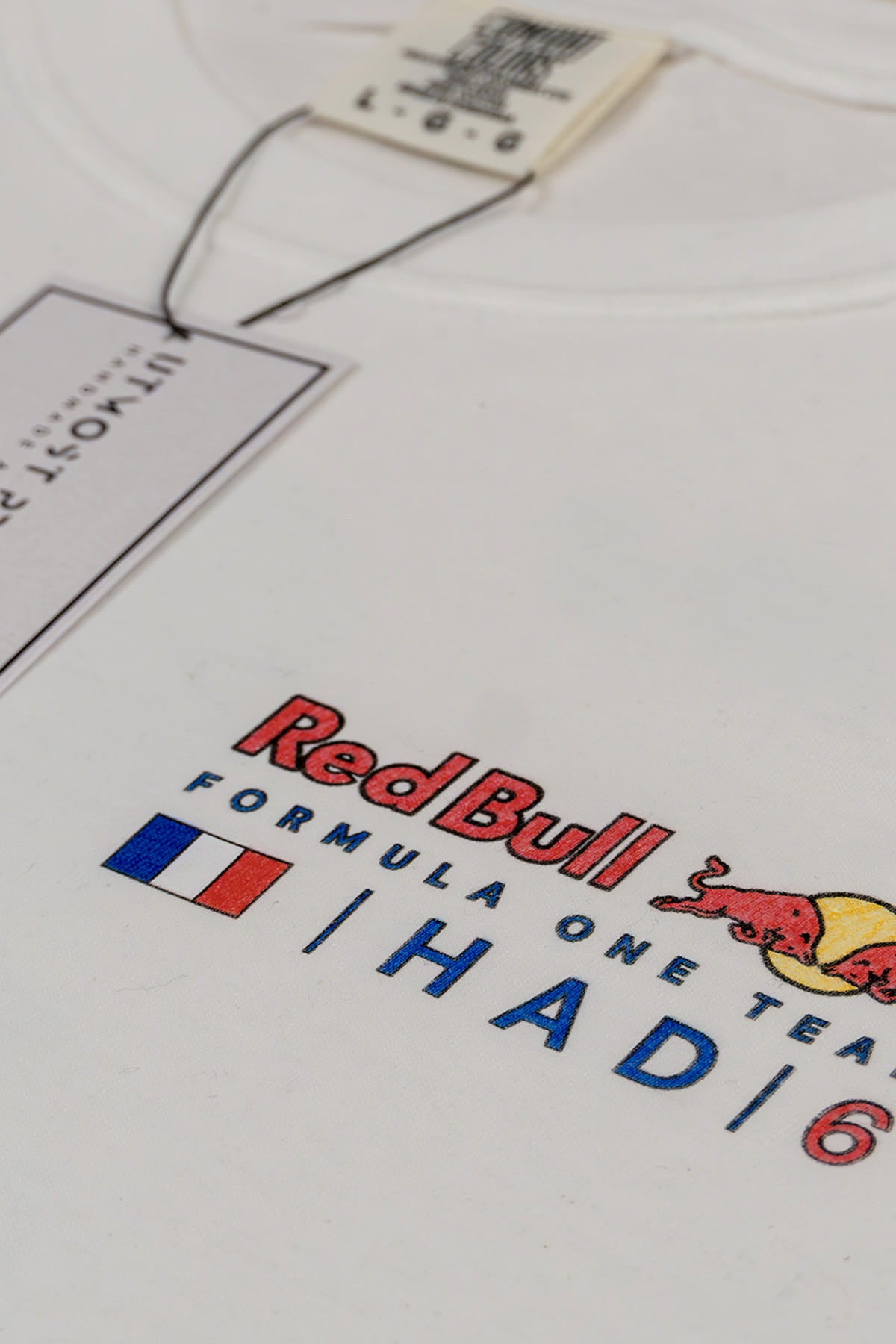 Close up of a custom Red Bull Racing shirt, highlighting the design on the front left chest of a white Comfort Colors cotton tee.