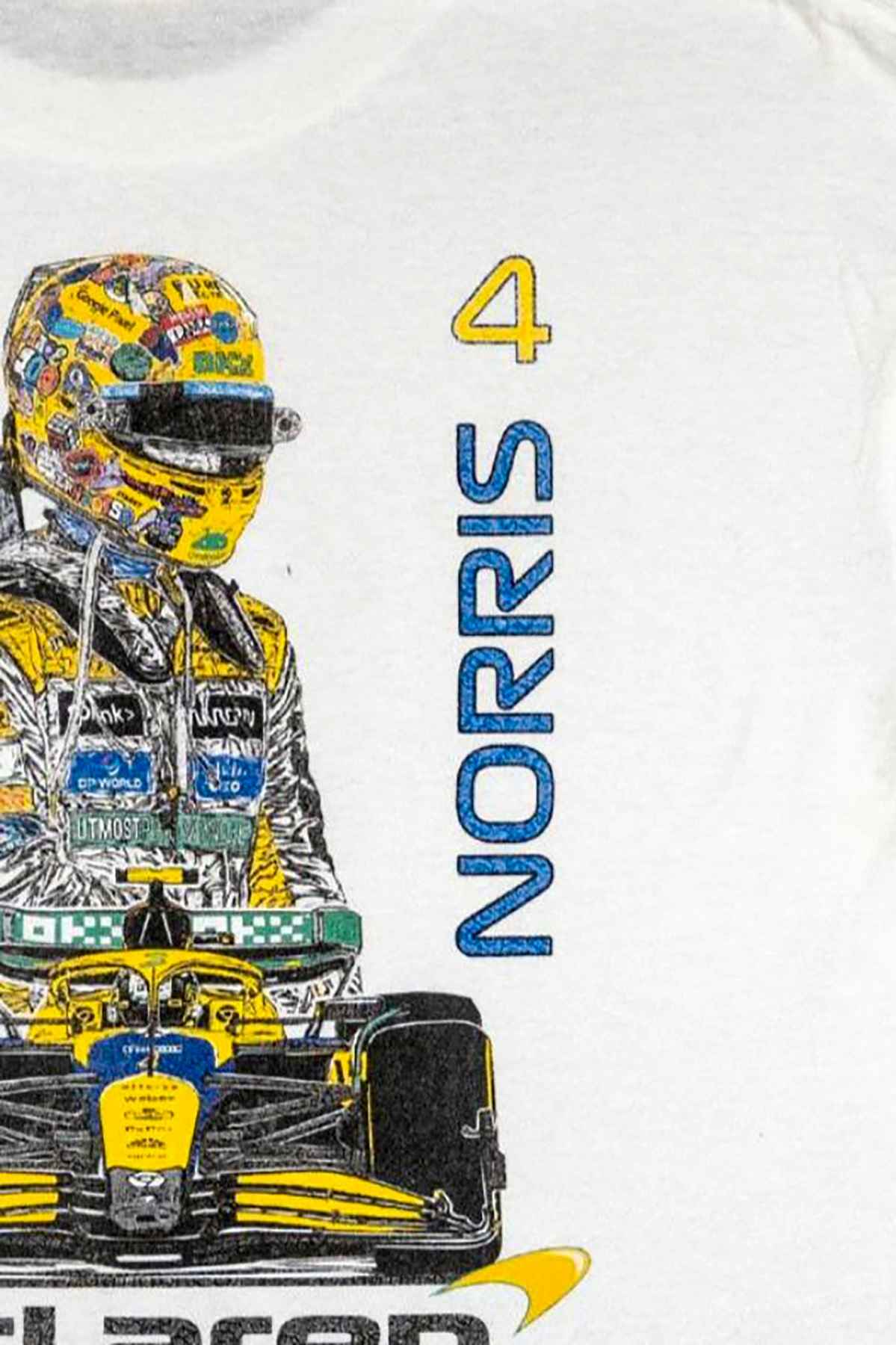 Utmost Province Lando Norris F1 shirt laid flat on a table, highlighting the graphic design on the back of the Mclaren F1 shirt.