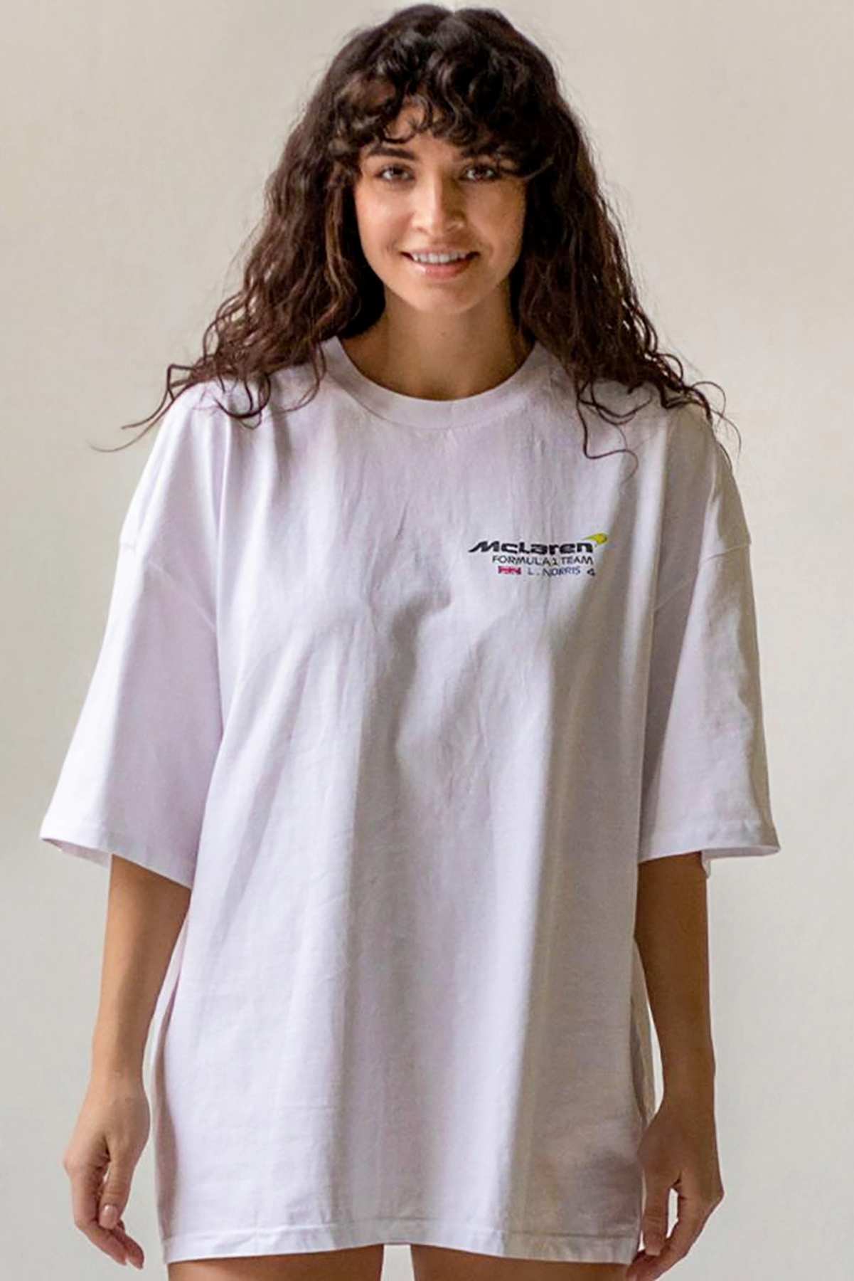 Model wearing Utmost Province custom Mclaren F1 shirt inspired by Lando Norris, showcasing the front graphic design on the Mclaren shirt.