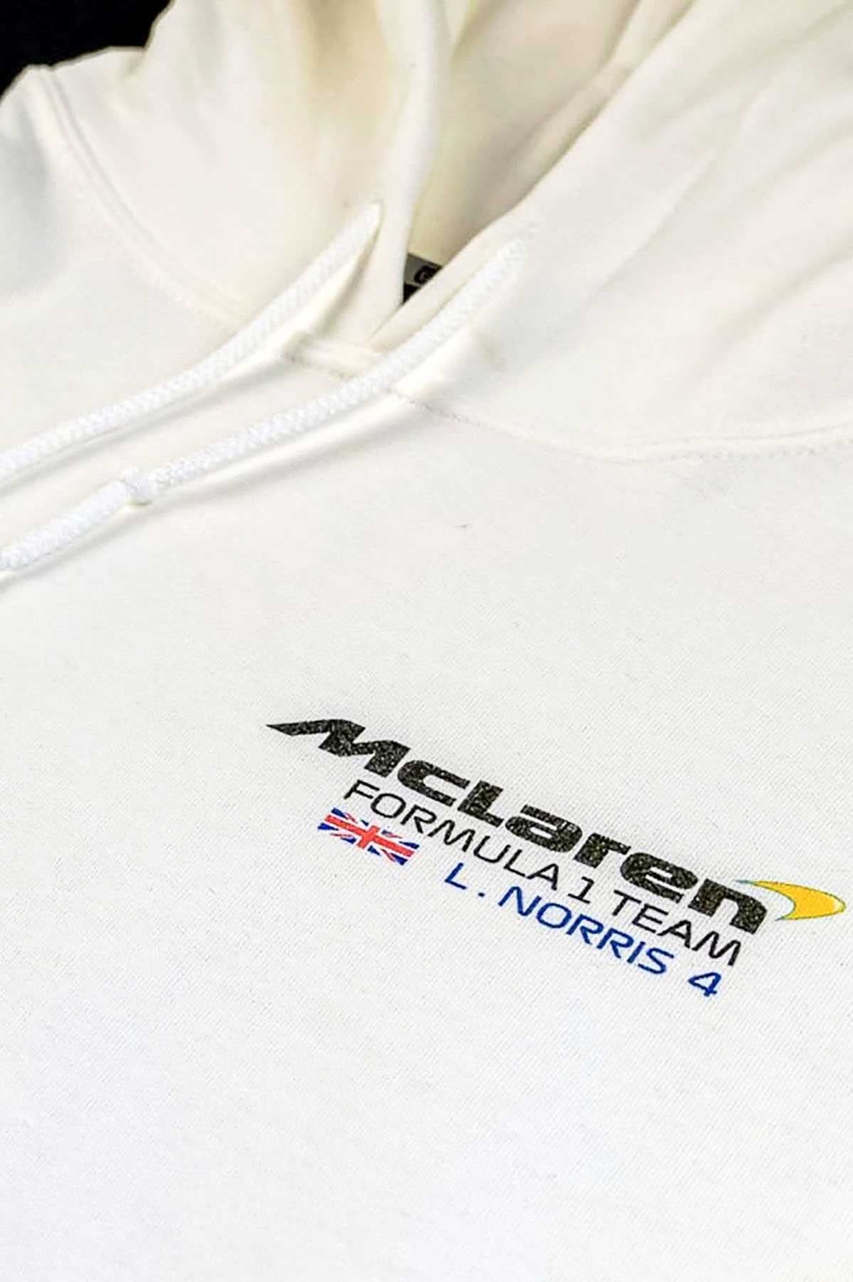 Utmost Province Mclaren hoodie laid flat on a table, highlighting the graphic design on the front of the Mclaren F1 merch for men and women.