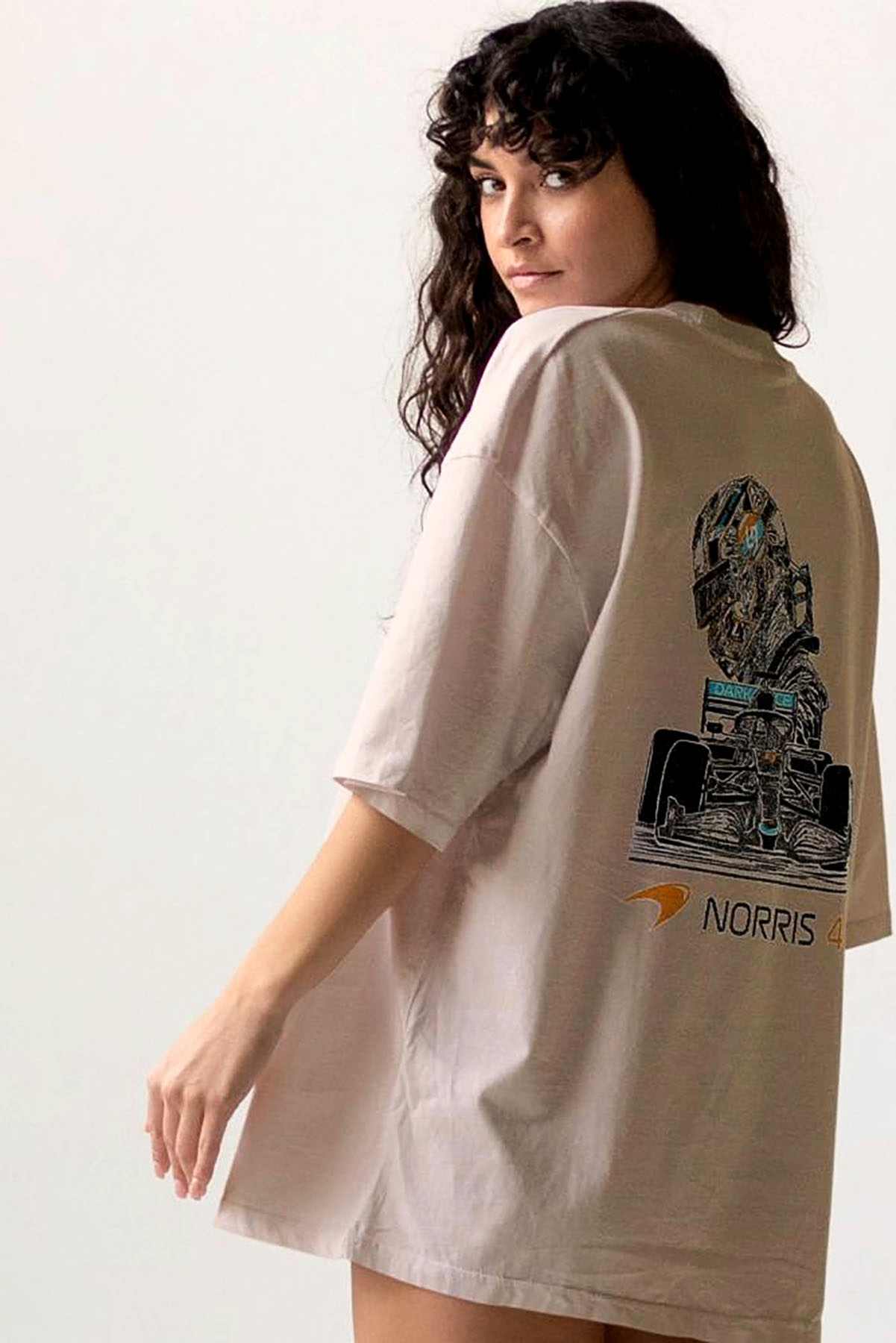 Model wearing Utmost Province Lando Norris Mclaren shirt, showcasing the graphic design on the back of the Mclaren F1 merch.