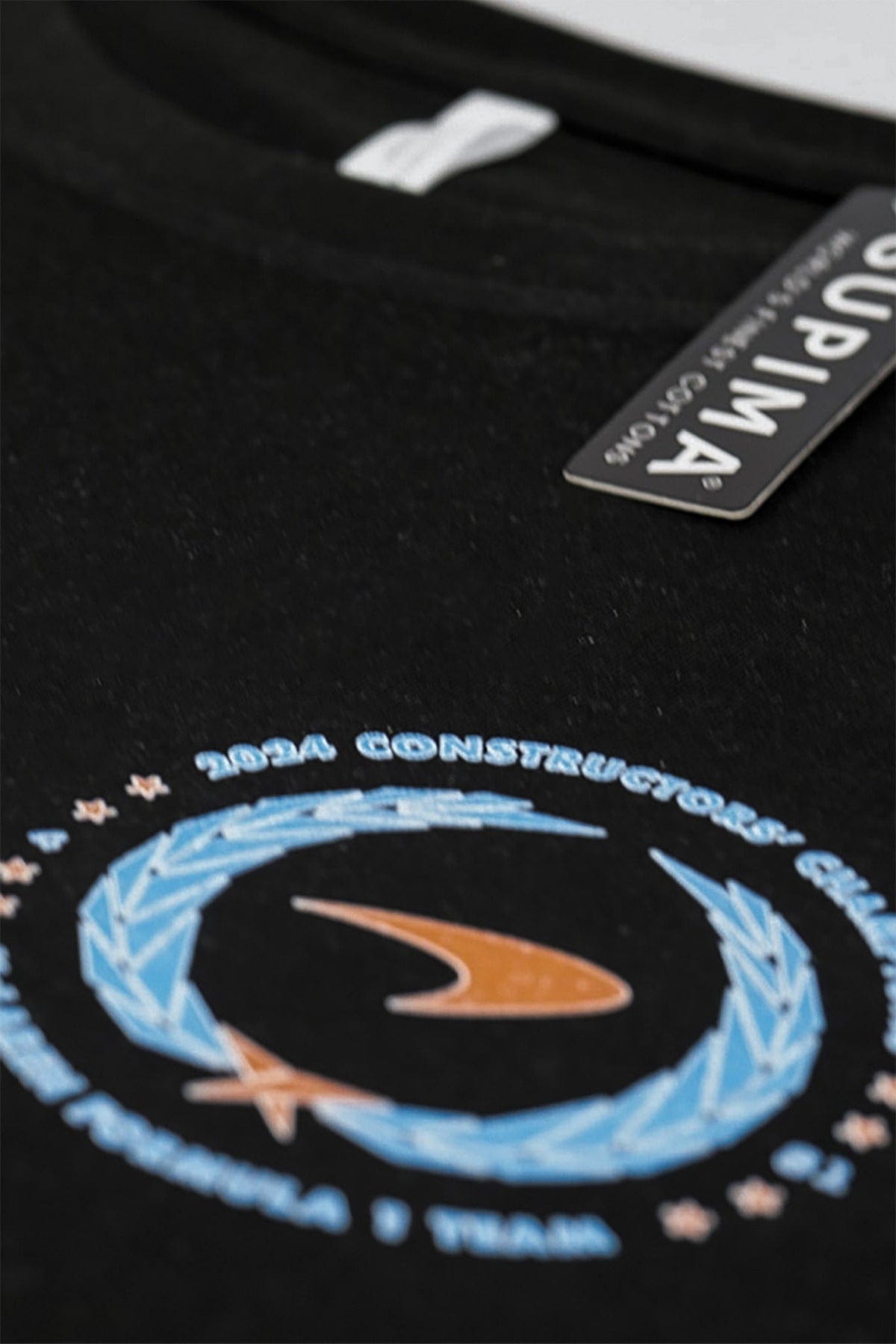 Detail image of the front graphic design of Utmost Province custom Mclaren t shirt on a black Supima cotton t-shirt