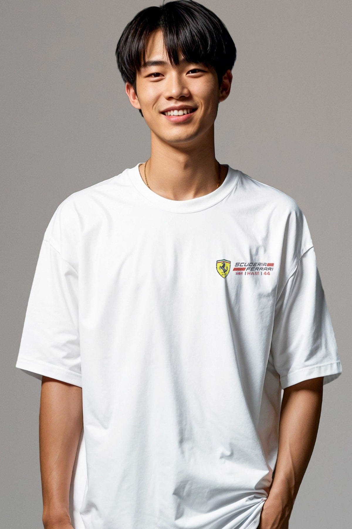 Person wearing a white t-shirt with a logo printed on the front left chest.