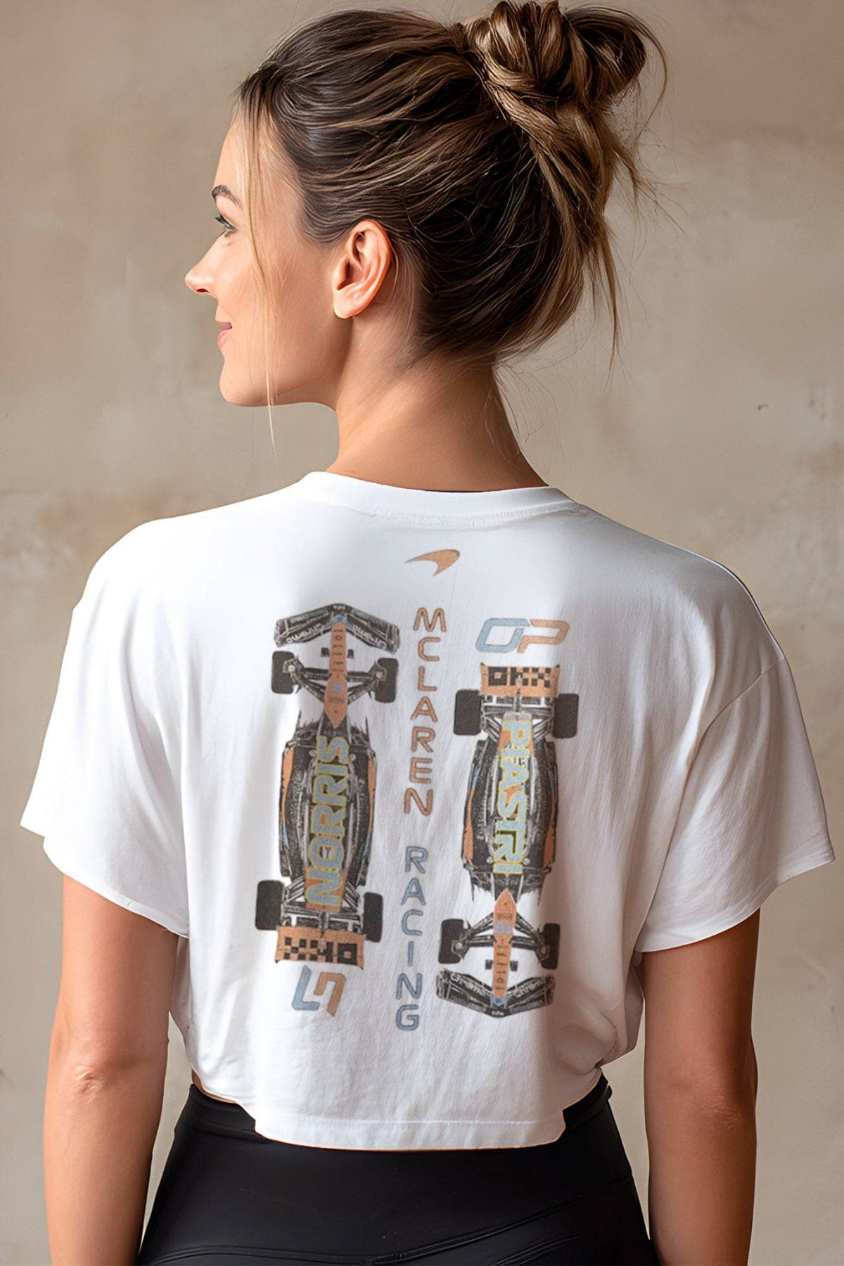 Women wearing a white McLaren F1-inspired crop top by Utmost Province®.