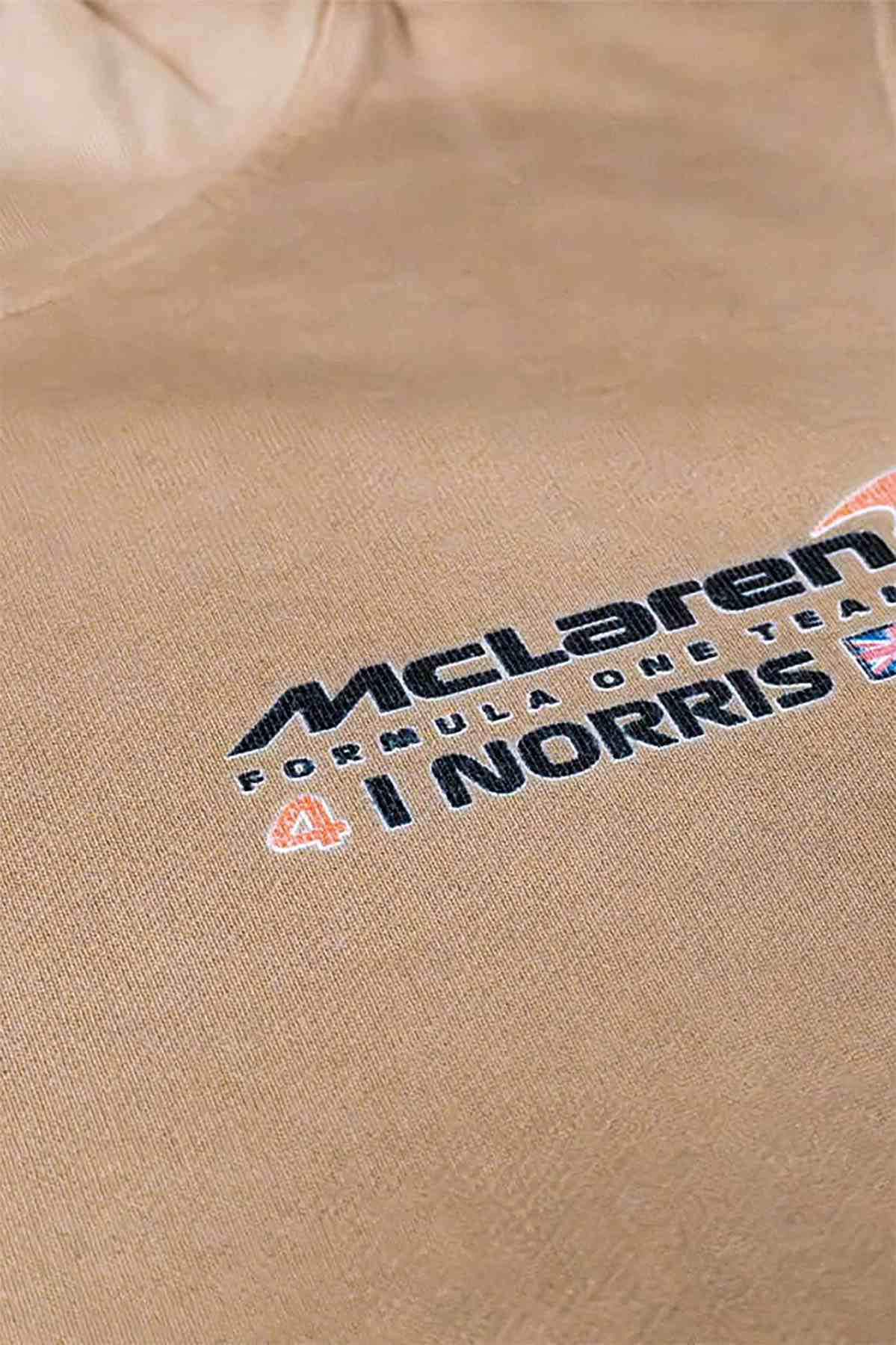 Mclaren F1 hoodie laid flat on a table, highlighting the custom graphic design on the Mclaren F1 merch.