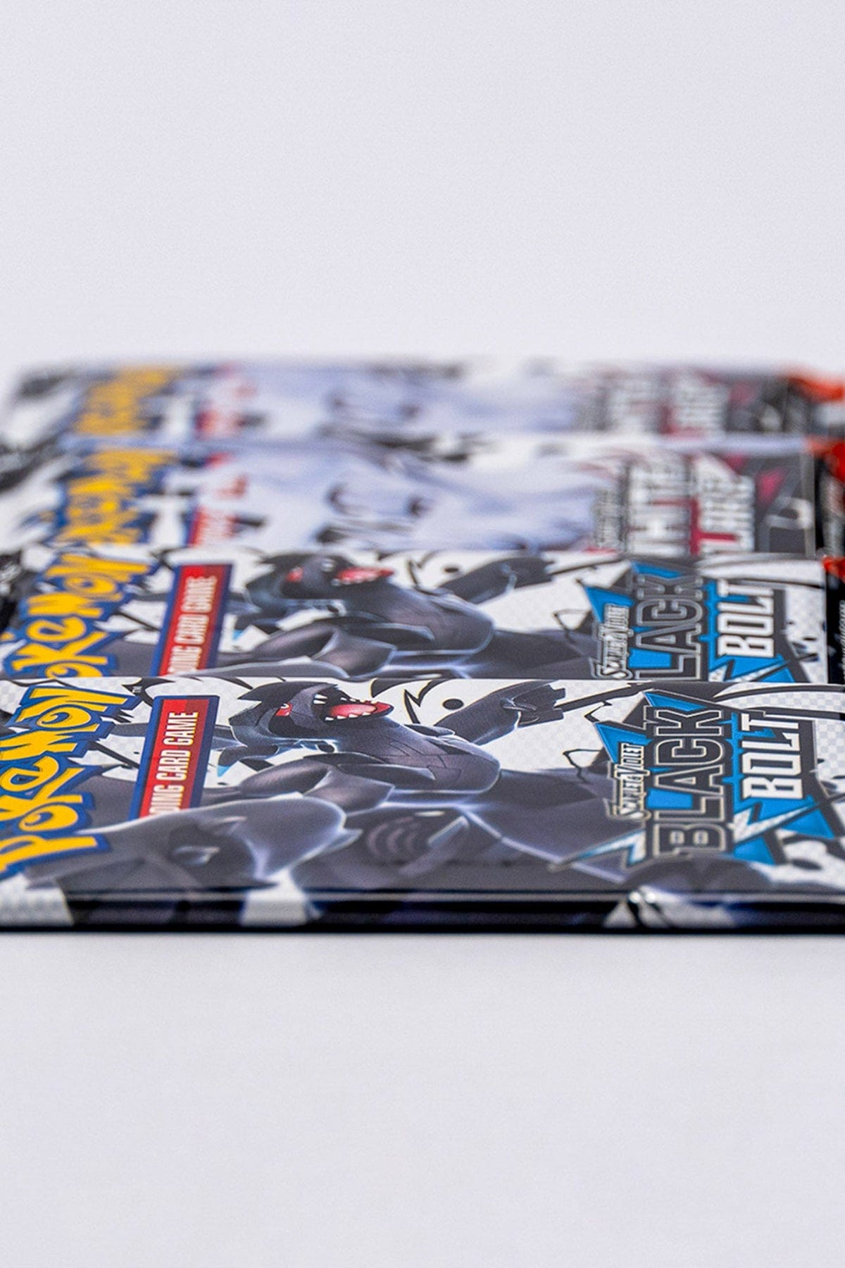 Close up of two Black Bolt booster packs and two White Flare booster packs.