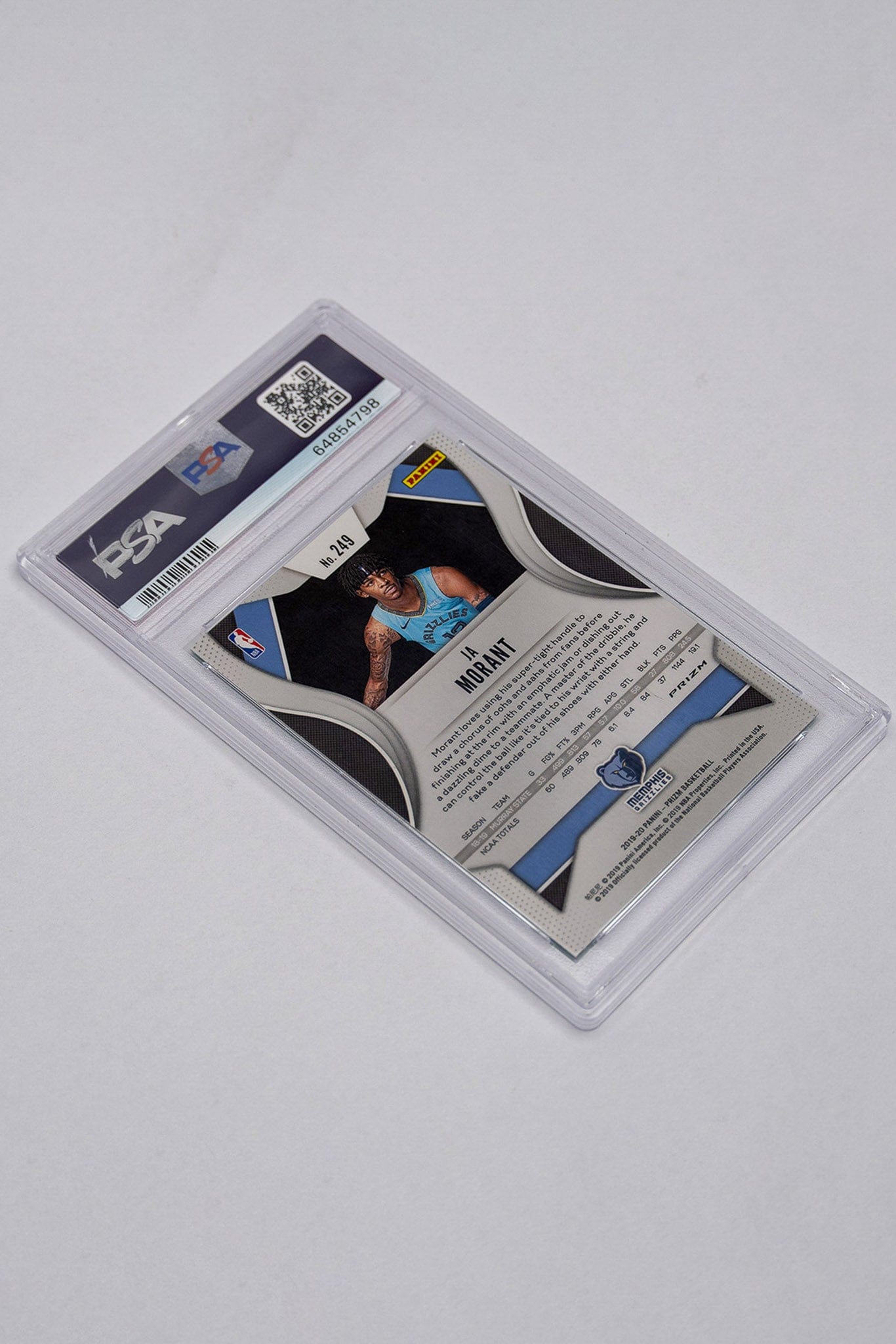 Back of Ja Morant Prizm rookie card on a white table.