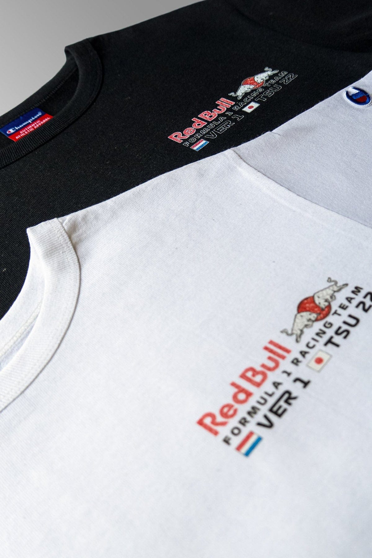 Close up of the front of a black and white custom Red Bull F1 crop top t shirt, highlighting Utmost Province unique design.