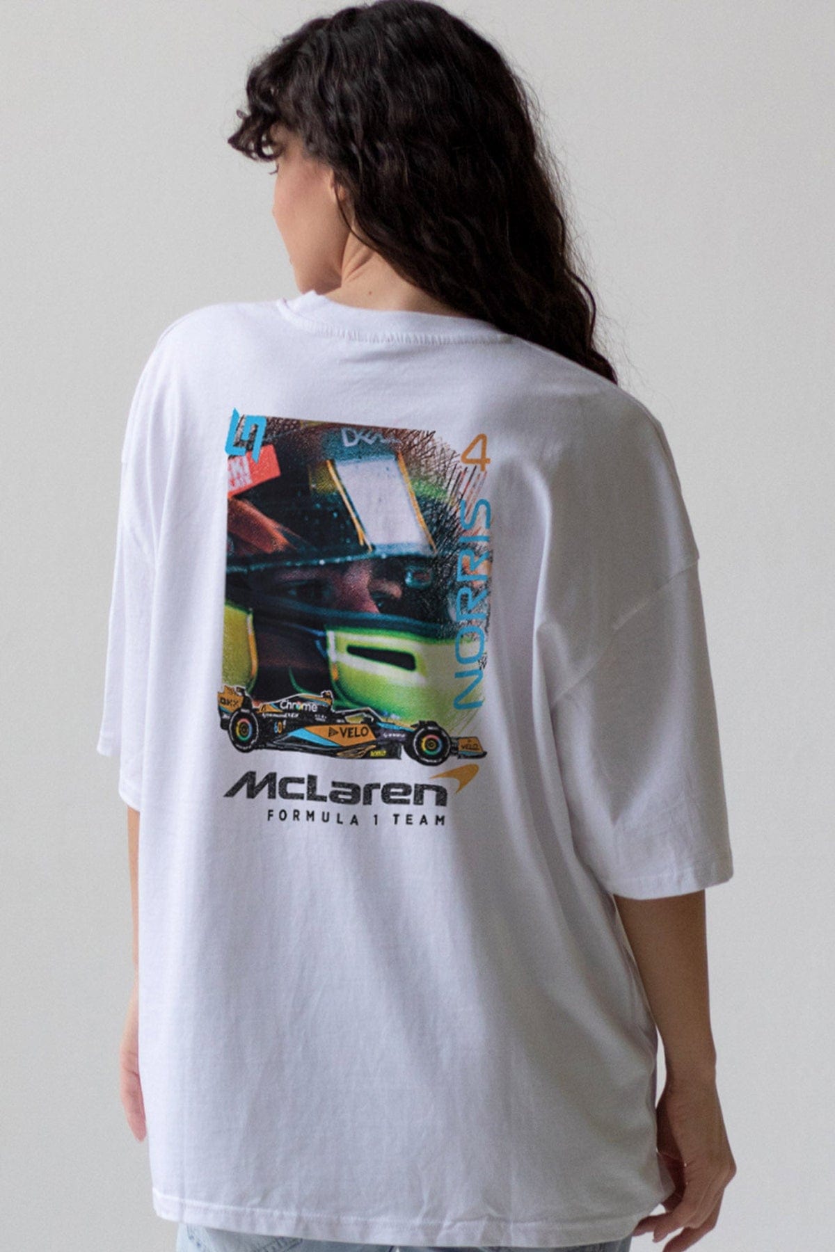 Model wearing a a white t-shirt, showcasing the graphic design inspired by Lando Norris on the back.