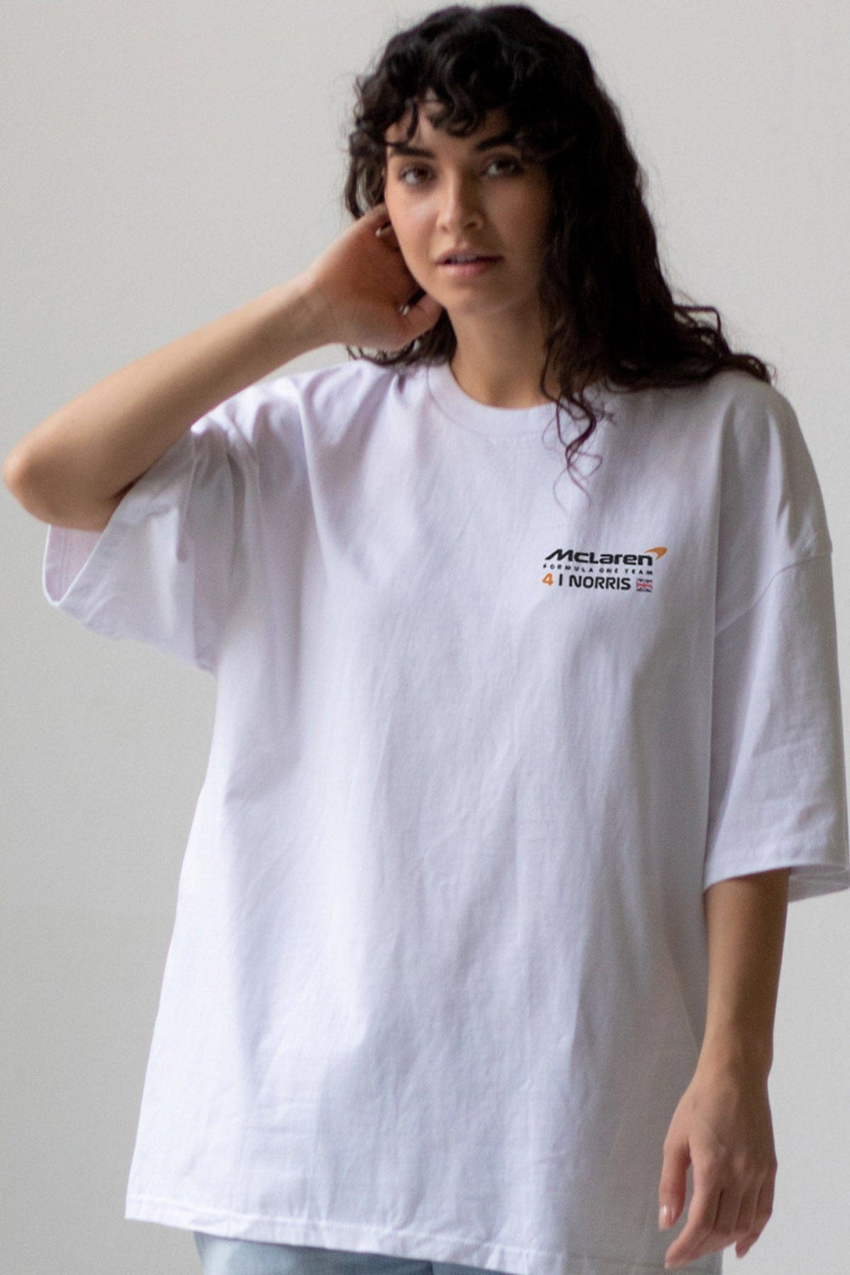 Model wearing Utmost Province's custom Mclaren F1 shirt, showcasing the front design.