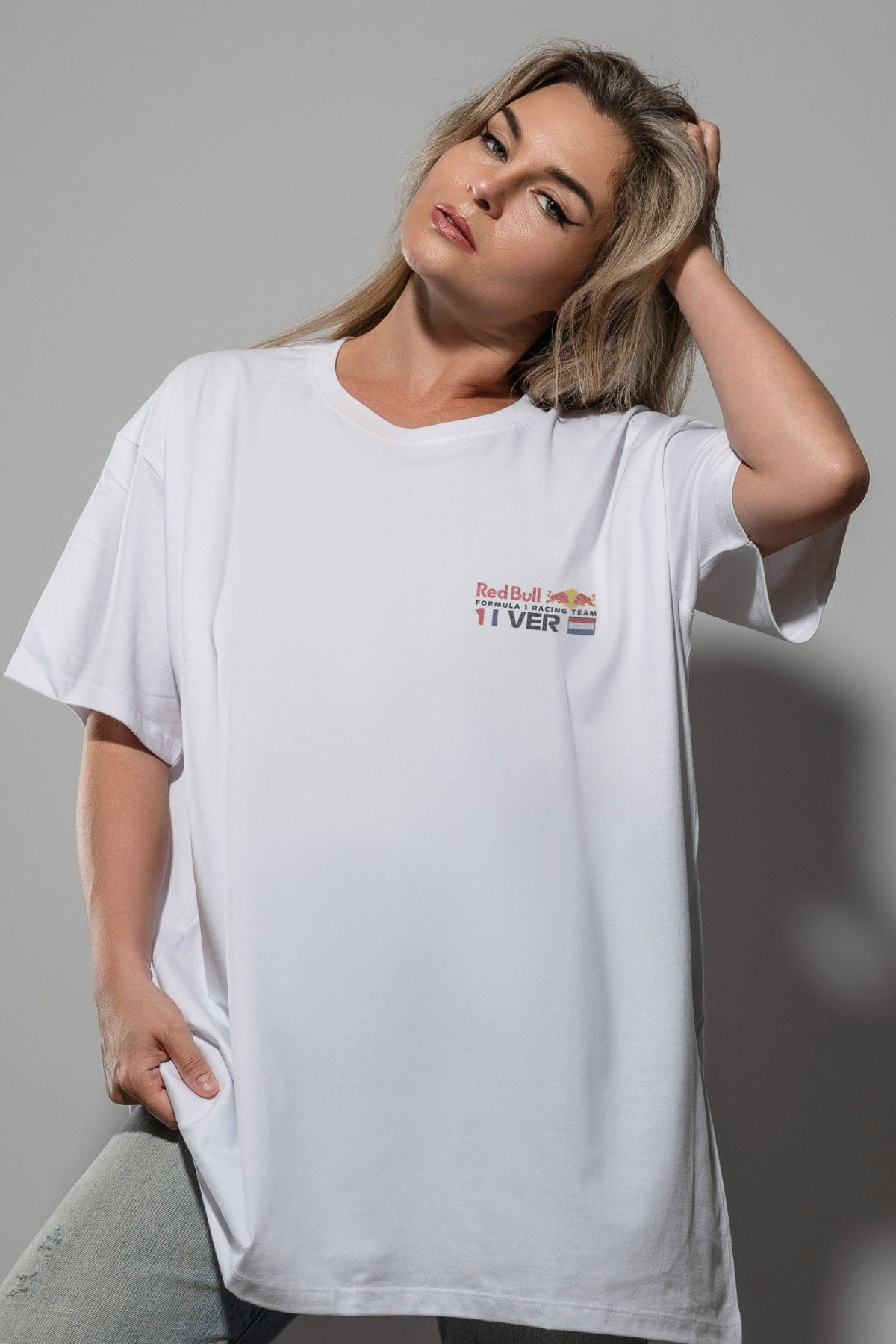 Woman wearing a white Comfort Colors shirt, featuring a custom Red Bull Racing F1 team logo.