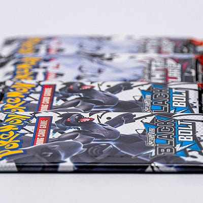 Pokemon card booster packs laid flat on a white table.