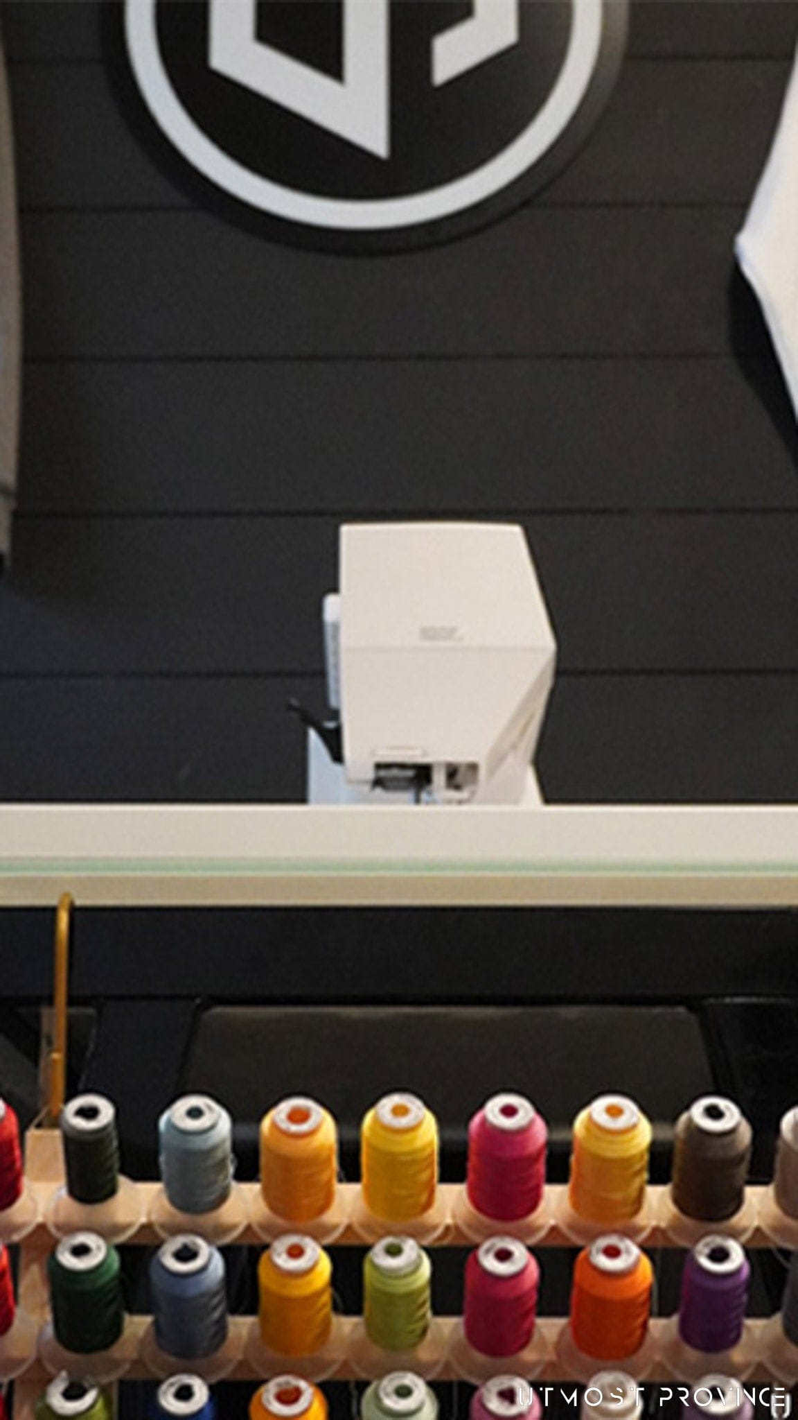 Embroidiery machine on a table, showcasing Utmost Province custom embroidiery services