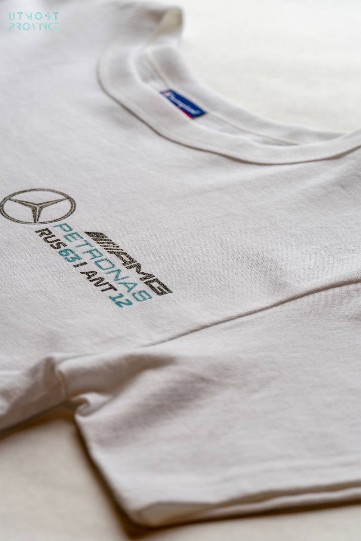Utmost Province Mercedes F1 team crop tops for women laid flat on a table, highlighting the graphic design on the front of the women's crop top shirt.