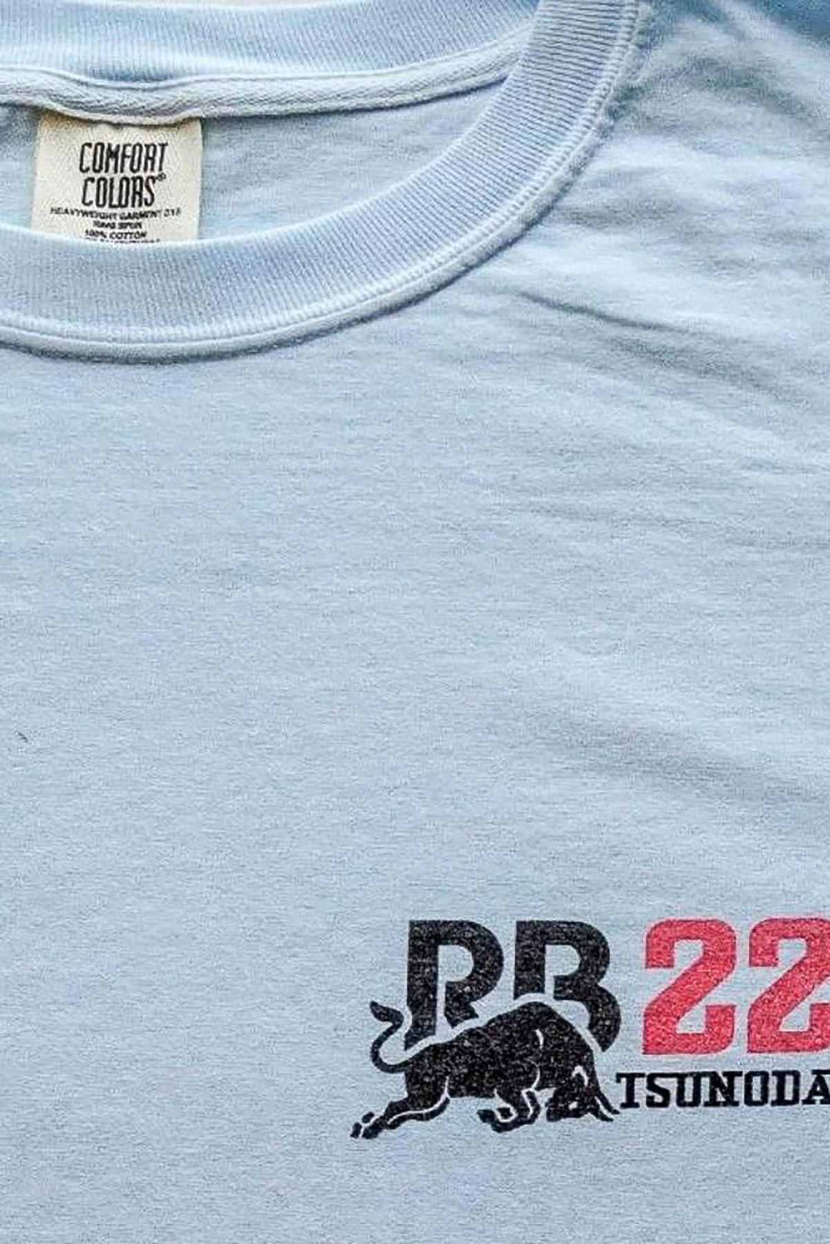 Utmost Province Visa Cash App RB F1 team t shirt laid flat on a table, highlighting the front left chest graphic design on the Red Bull racing t shirt.