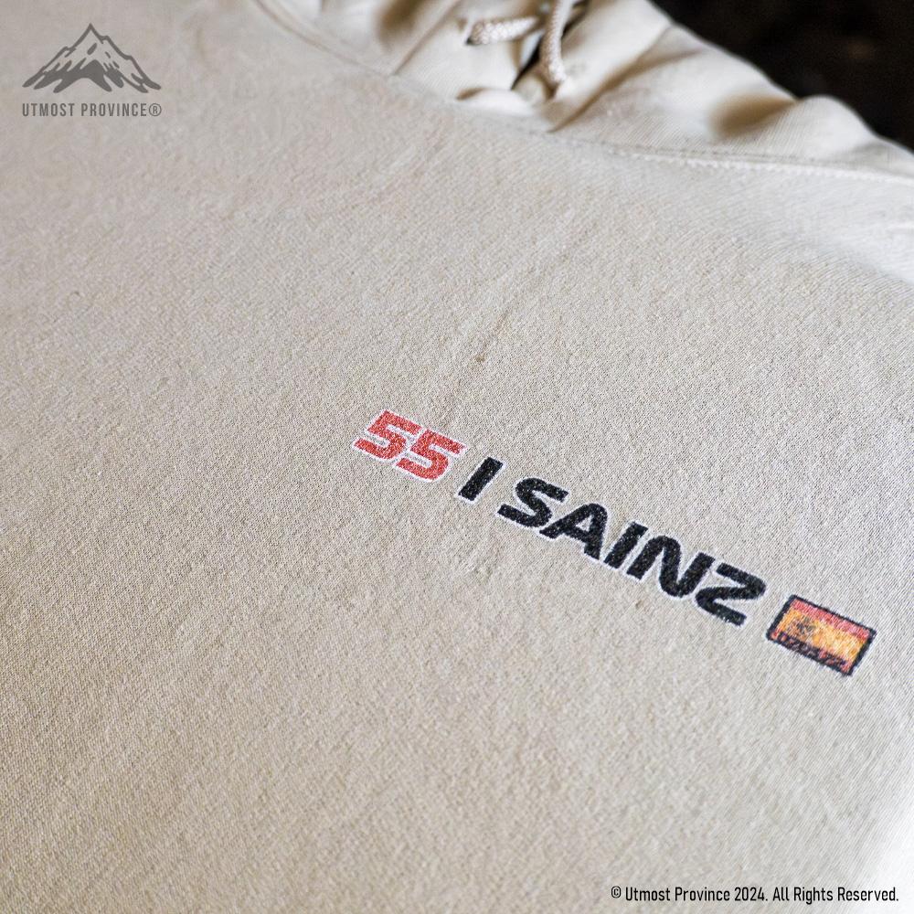 Carlos Sainz inspired Ferrari F1 hoodie laid flat on a table, highlighting the front left chest design of the hooded sweatshirt.