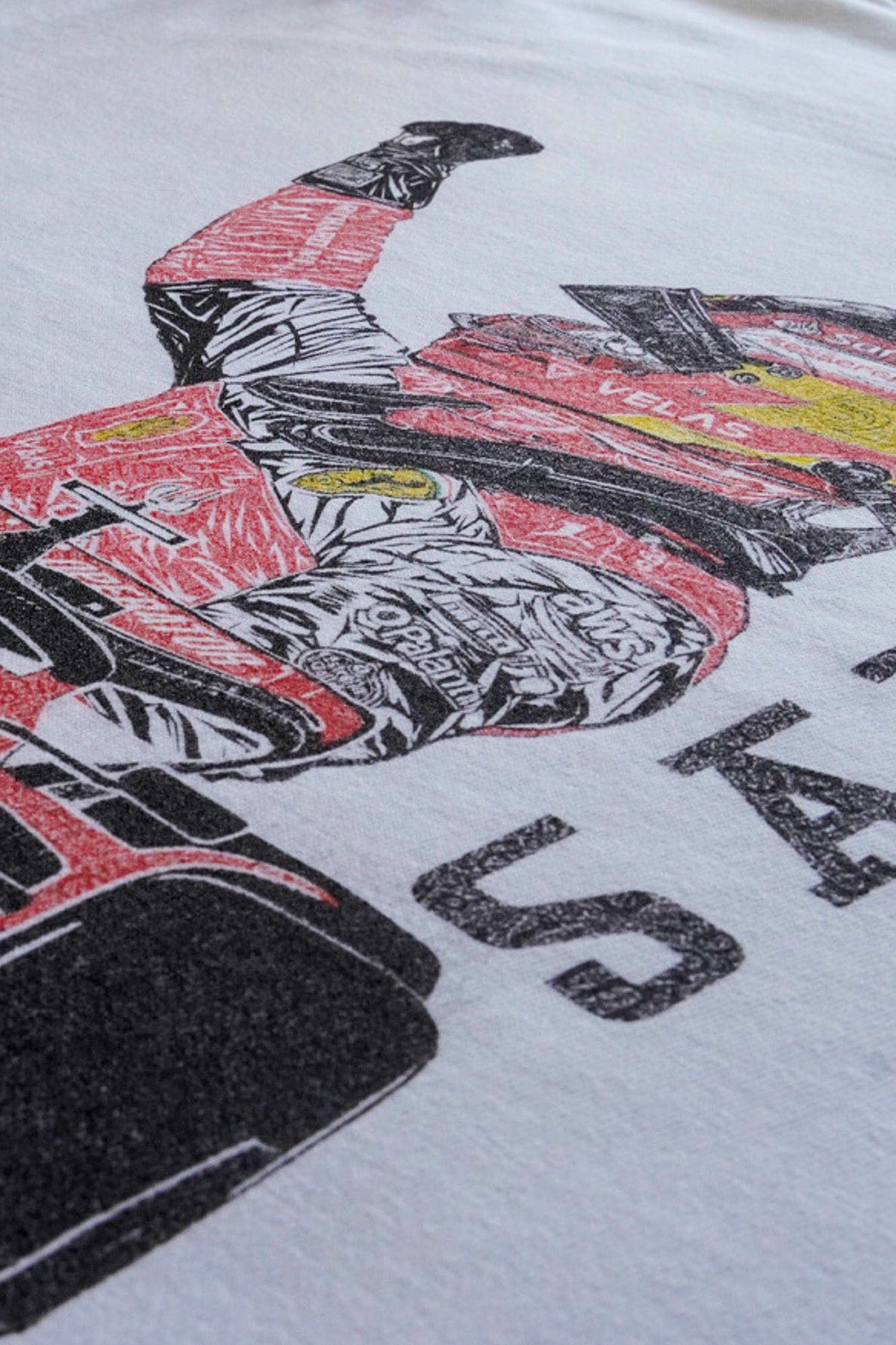 Close up of Utmost Province custom Carlos Sainz Ferrari T-Shirt, showcasing the graphic design on the back.
