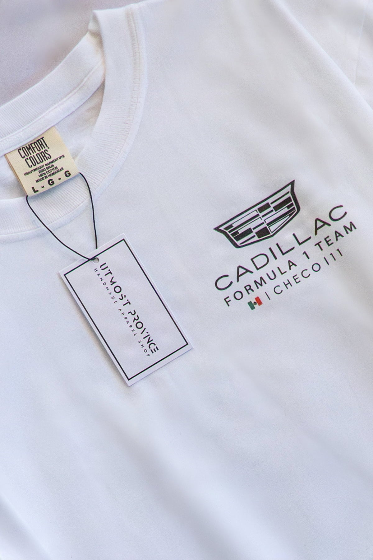 Close-up of white Cadillac F1 shirt by Utmost Province, featuring a custom Cadillac Formula 1 Team inspired design  on front chest, DTG printed.