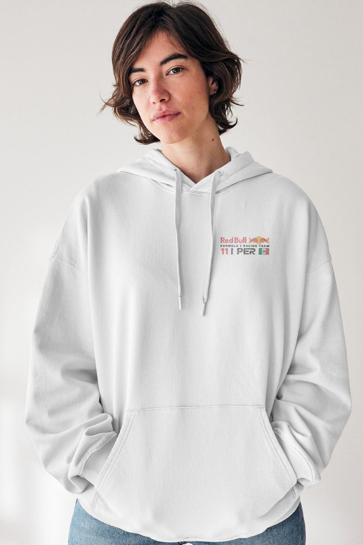 Model wearing a white hoodie,, showcasing the custom Red Bull F1 logo on the front.