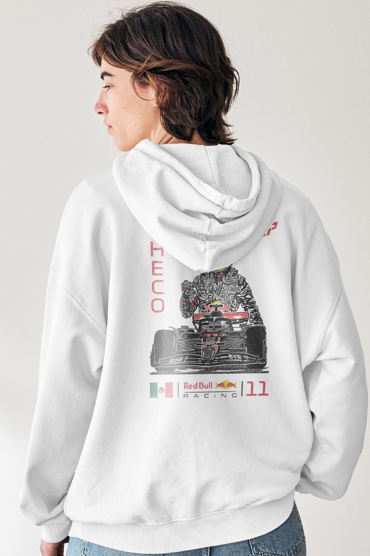 Woman wearing a white hoodie featuring a Checo Perez inspired graphic design on the back.
