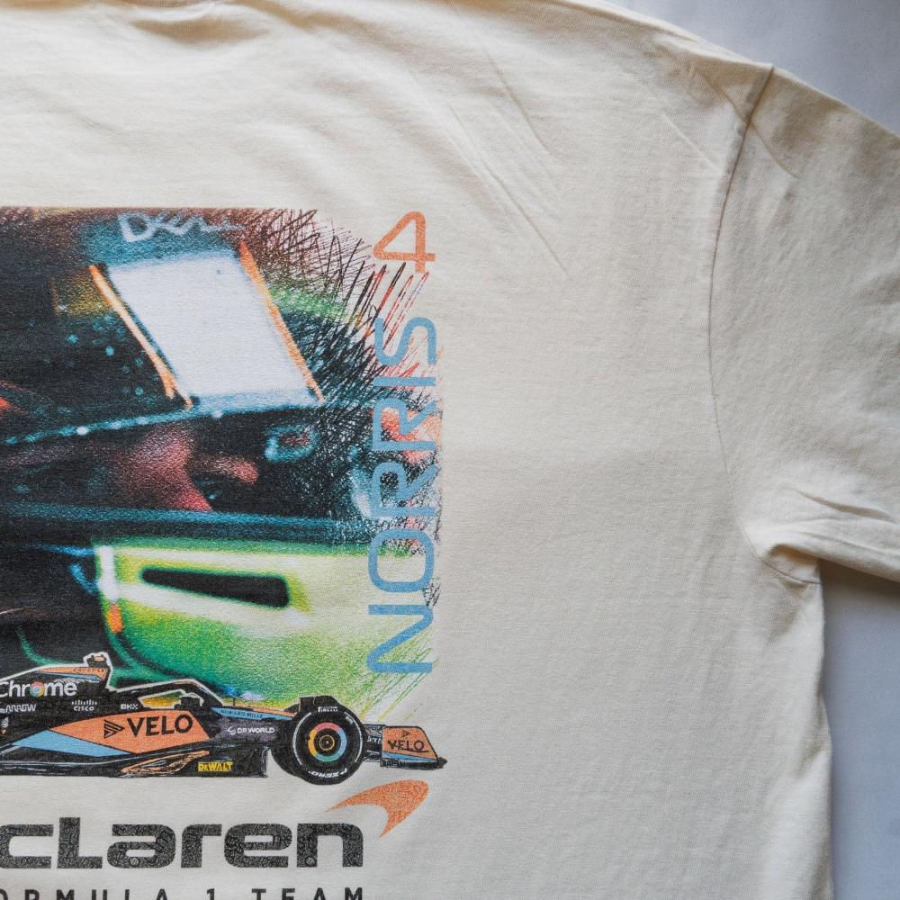 Close-up image of Utmost Province's custom Mclaren racing shirt, highlighting the details of the back of a F1 retro t shirt.