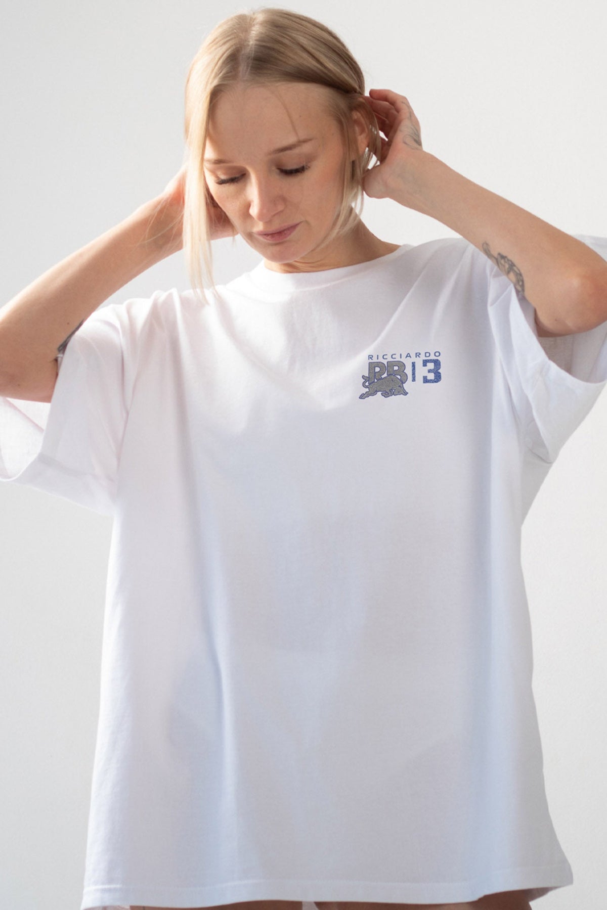 Model wearing Utmost Province custom Daniel Ricciardo t shirt, highlighting the graphic design on the front of the Formula 1 shirt.
