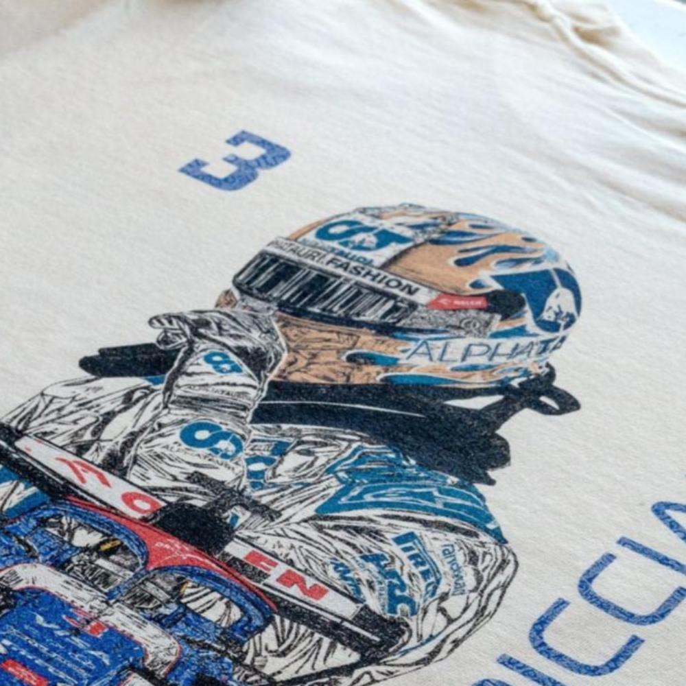 Daniel Ricciardo inspired graphic tee laid flat on a table, highlighting the details of the t-shirt design.