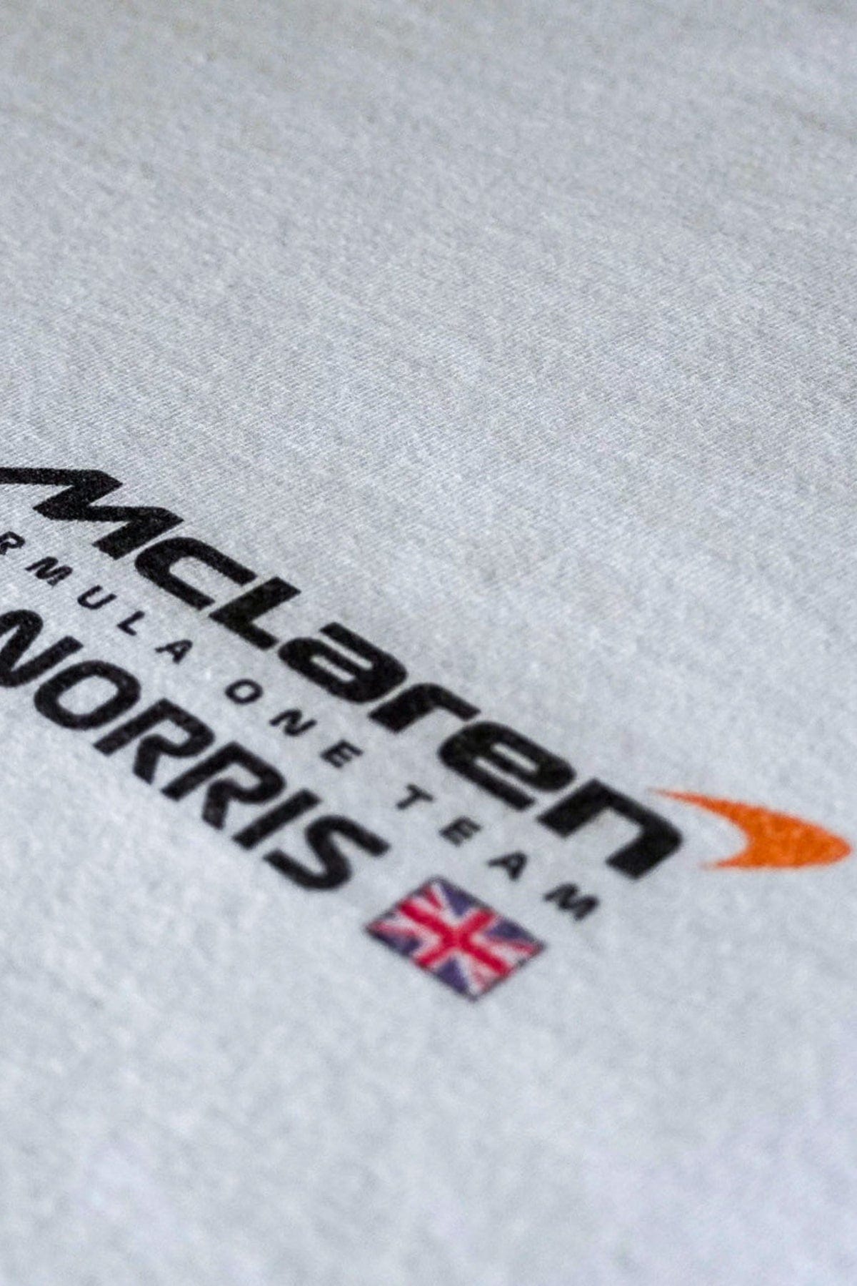 Front of a white t-shirt featuring Utmost Province custom designed Mclaren logo