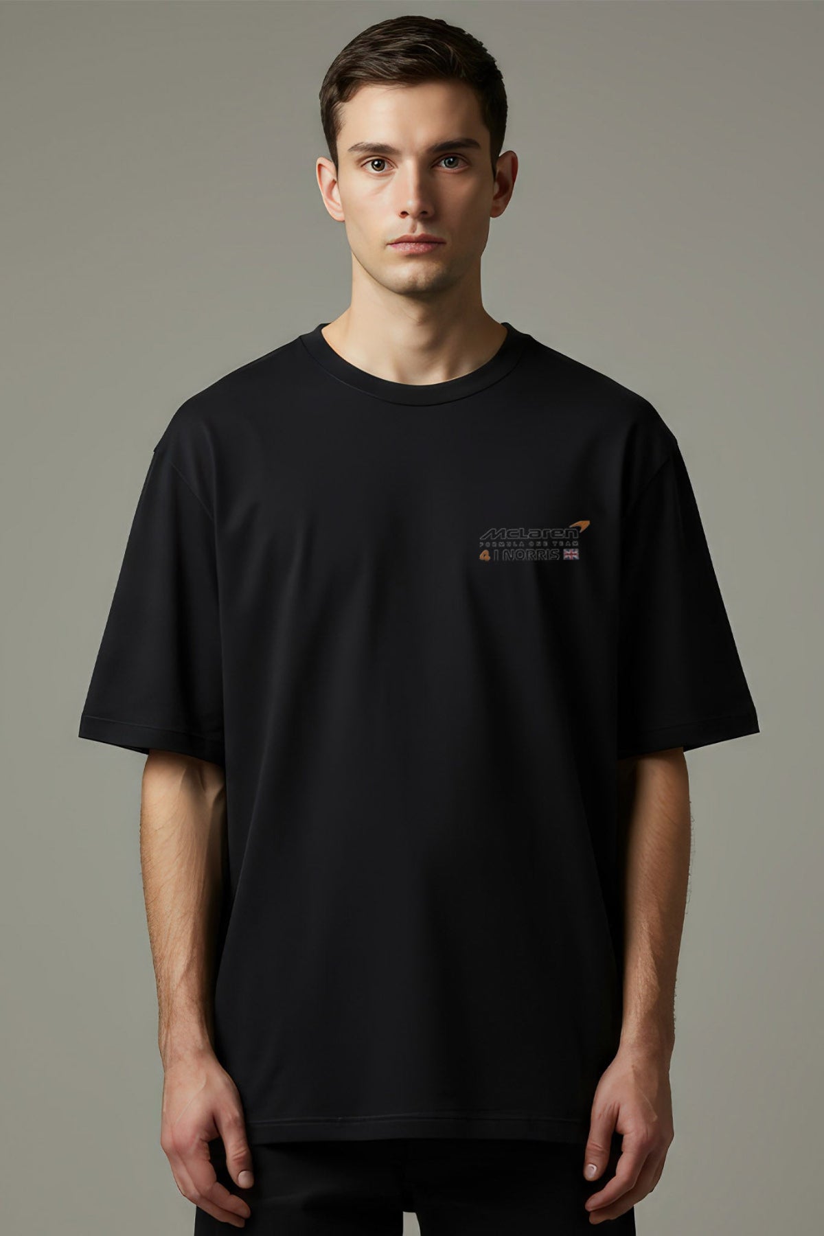 Man wearing a black t-shirt with a custom Mclaren F1 team logo on the front.