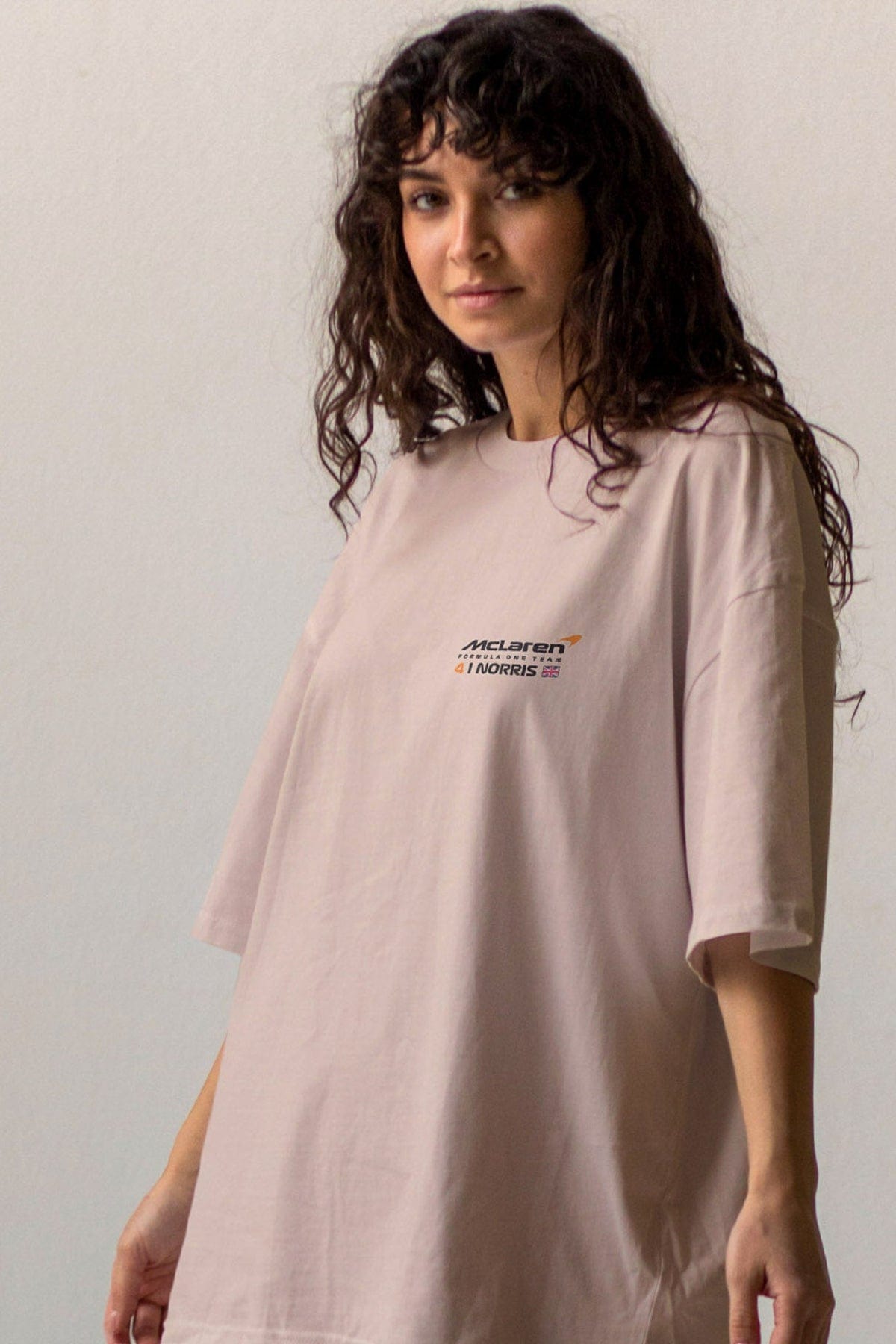 Person wearing a beige custom Comfort Colors t-shirt, featuring Utmost Province Mclaren F1 design.