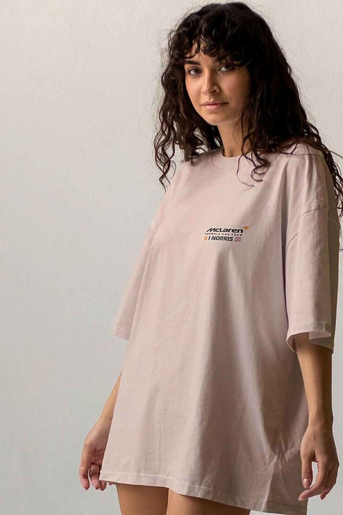 Model wearing Utmost Province Lando Norris T shirt, showcasing the graphic design on the front of the Mclaren F1 merch.