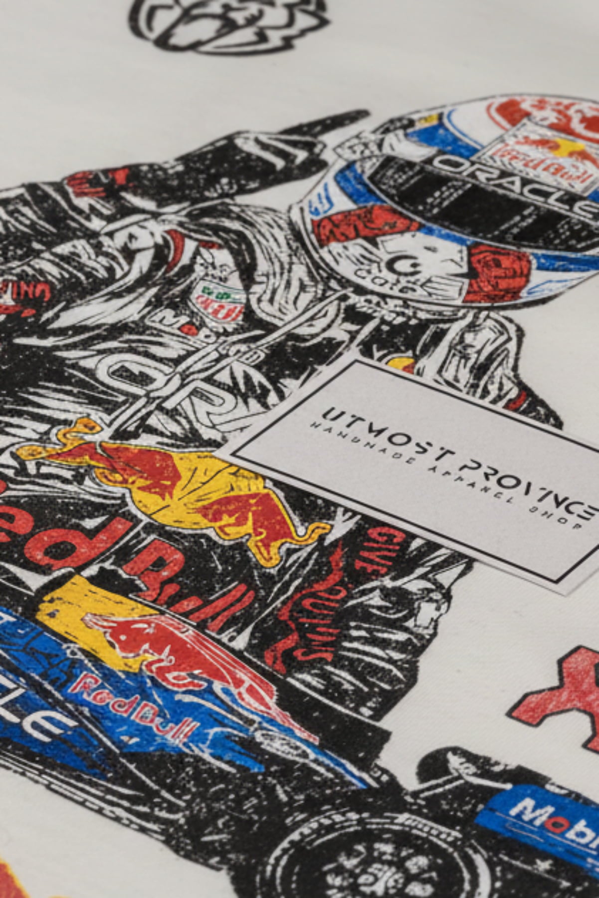 Close up back view of Utmost Province Red Bull F1 inspired graphic tee, highlighting the details of the design on the back of a white Comfort Colors shirt.