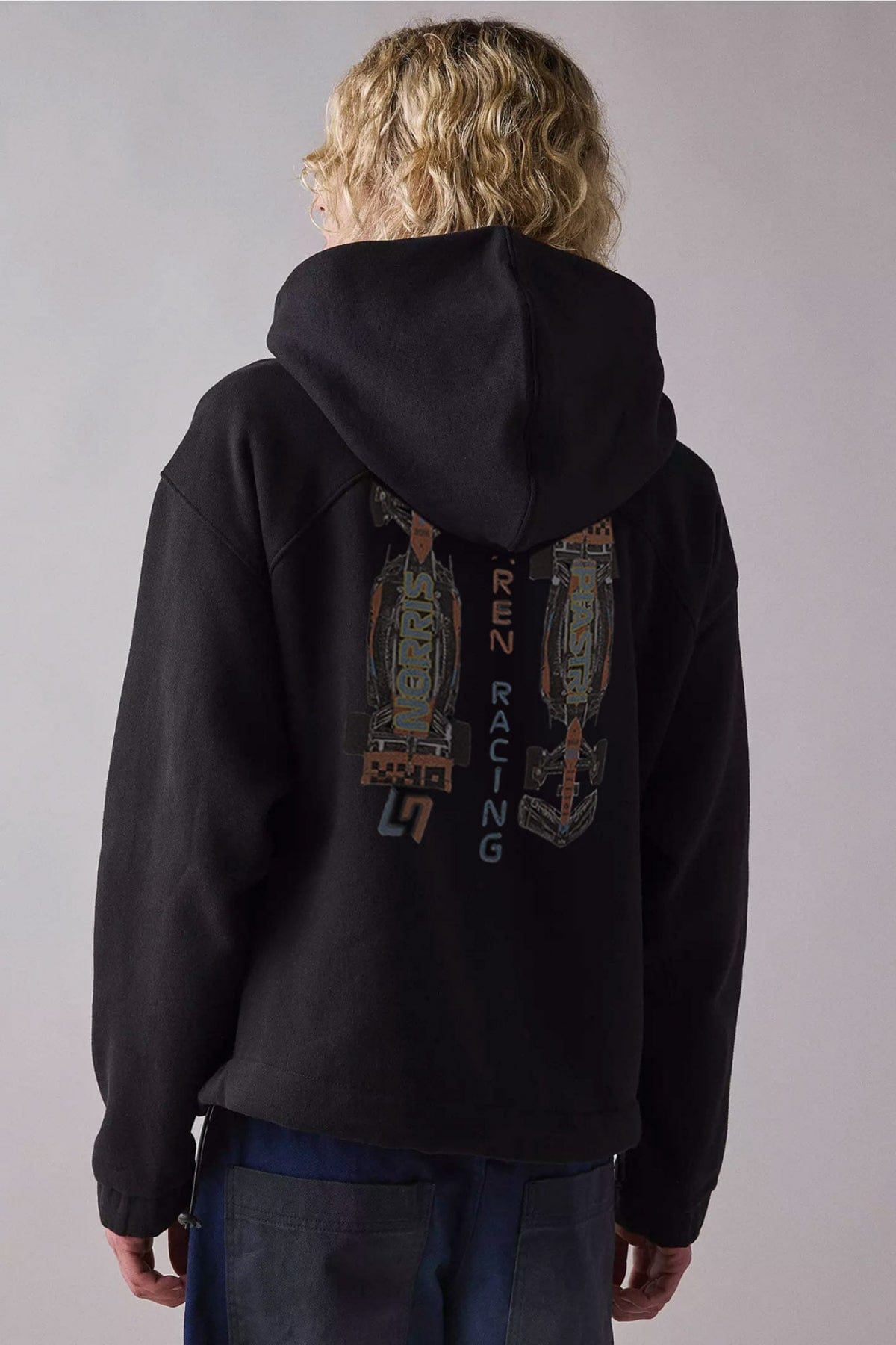 Person wearing a black custom Mclaren hoodie designed by Utmost Province, showcasing the front design.