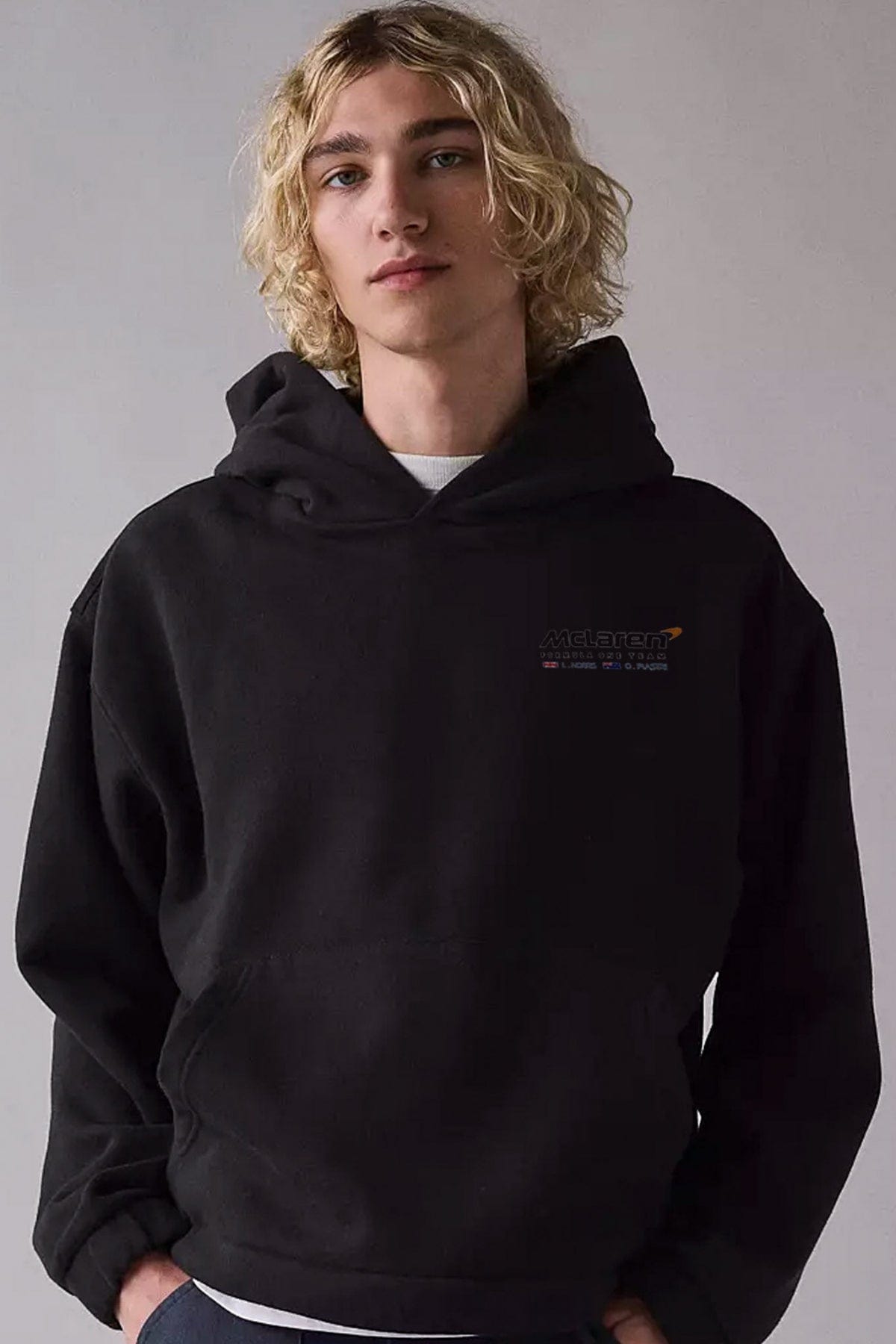 Person wearing a black organic cotton hoodie, showcasing the graphic design by Utmost Province.