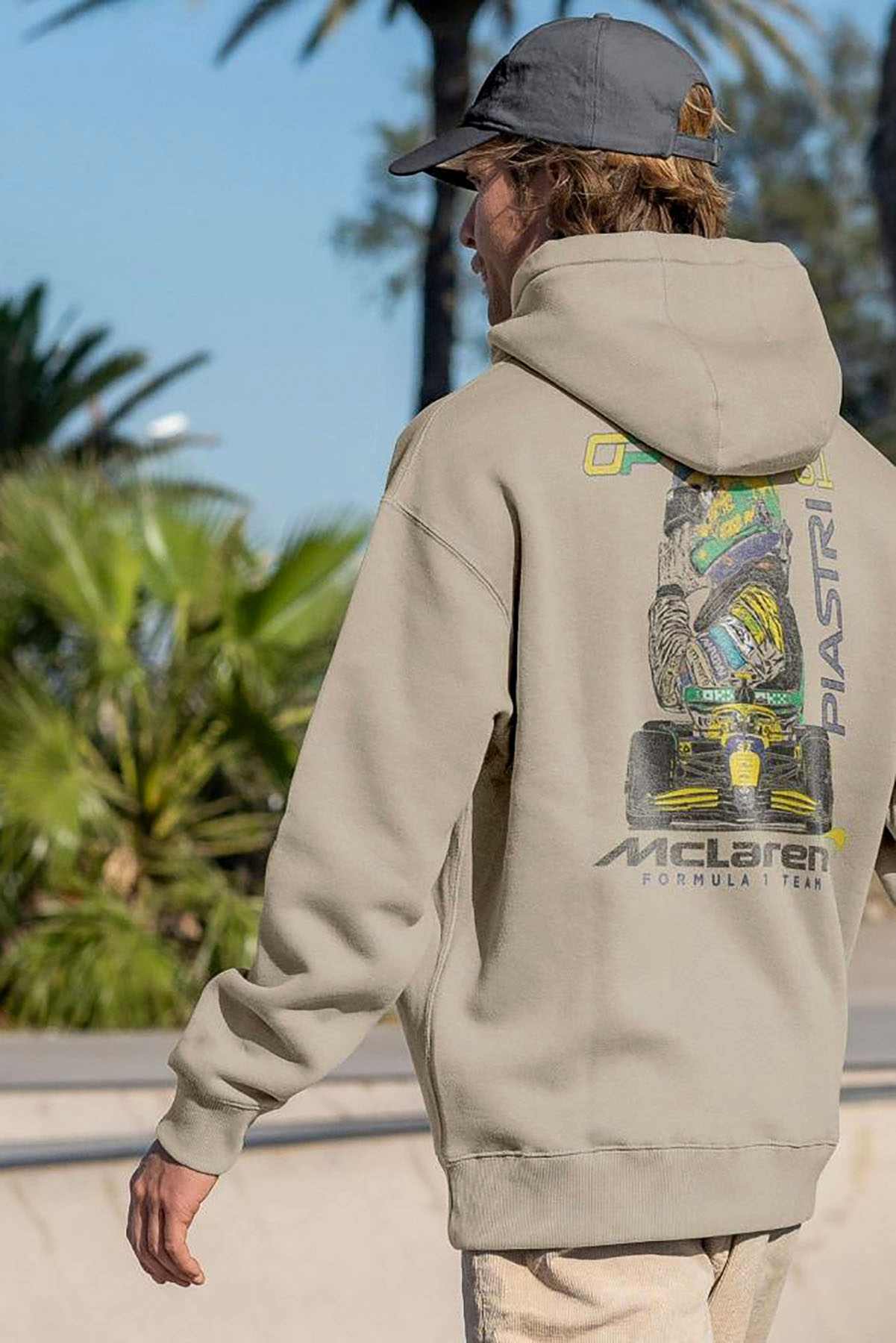 Model wearing Utmost Province Mclaren F1 hoodie, showcasing the graphic design on the back of the Oscar Piastri merch.