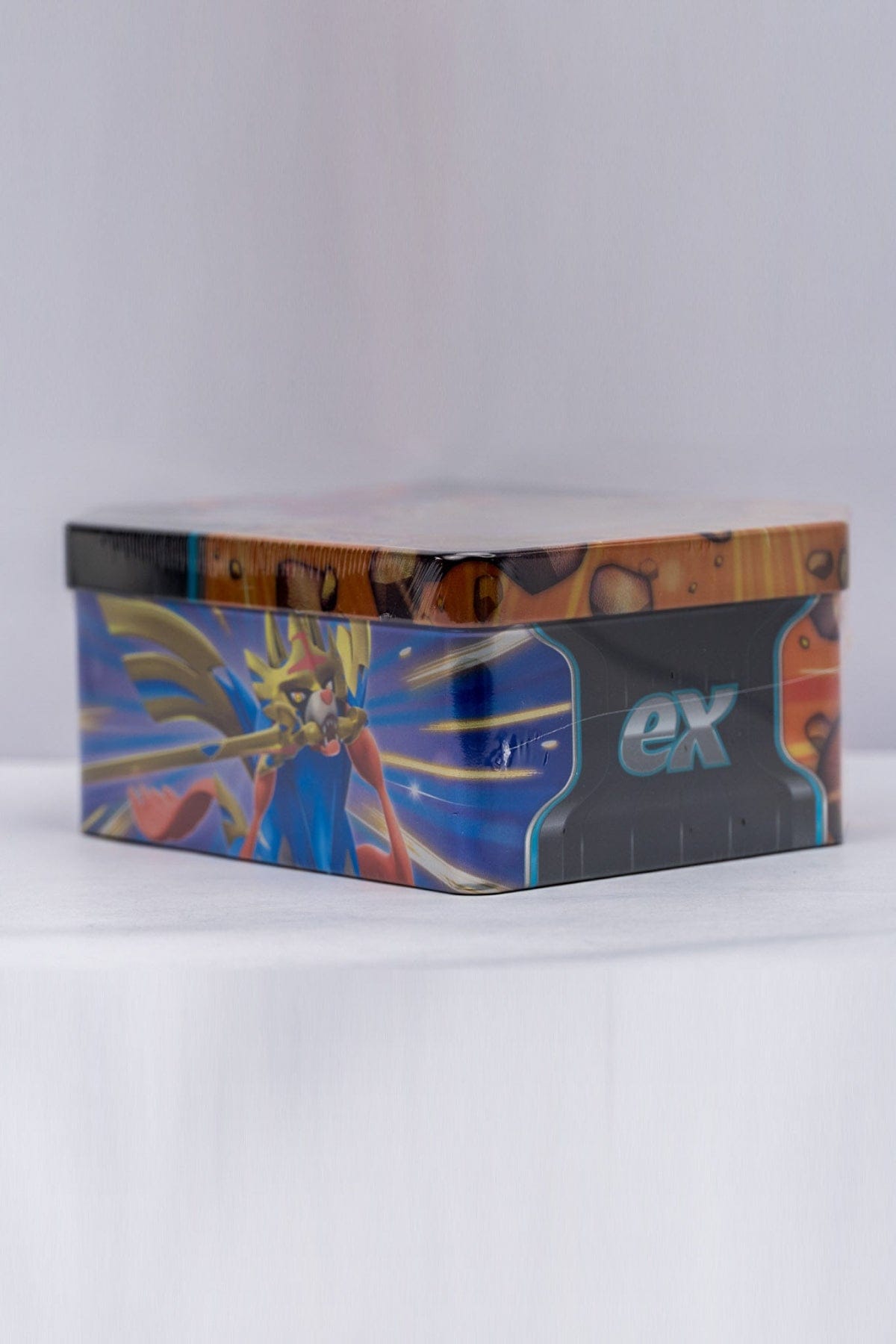 Side of a Pokemon Slashing Legends Trading Card Tin