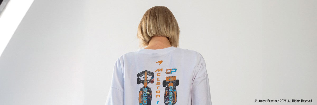 Custom Mclaren F1 merch presented by a Formula 1 fan. The image shows a model that showcases one of the t-shirts from Utmost Province's F1 Race Car T shirt collection.