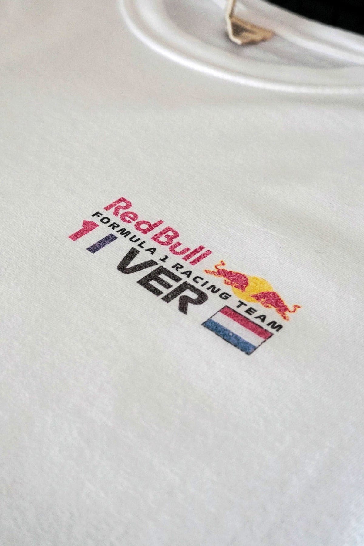 Front of a White Comfort Colors shirt, laid flat, to show the details of the design.